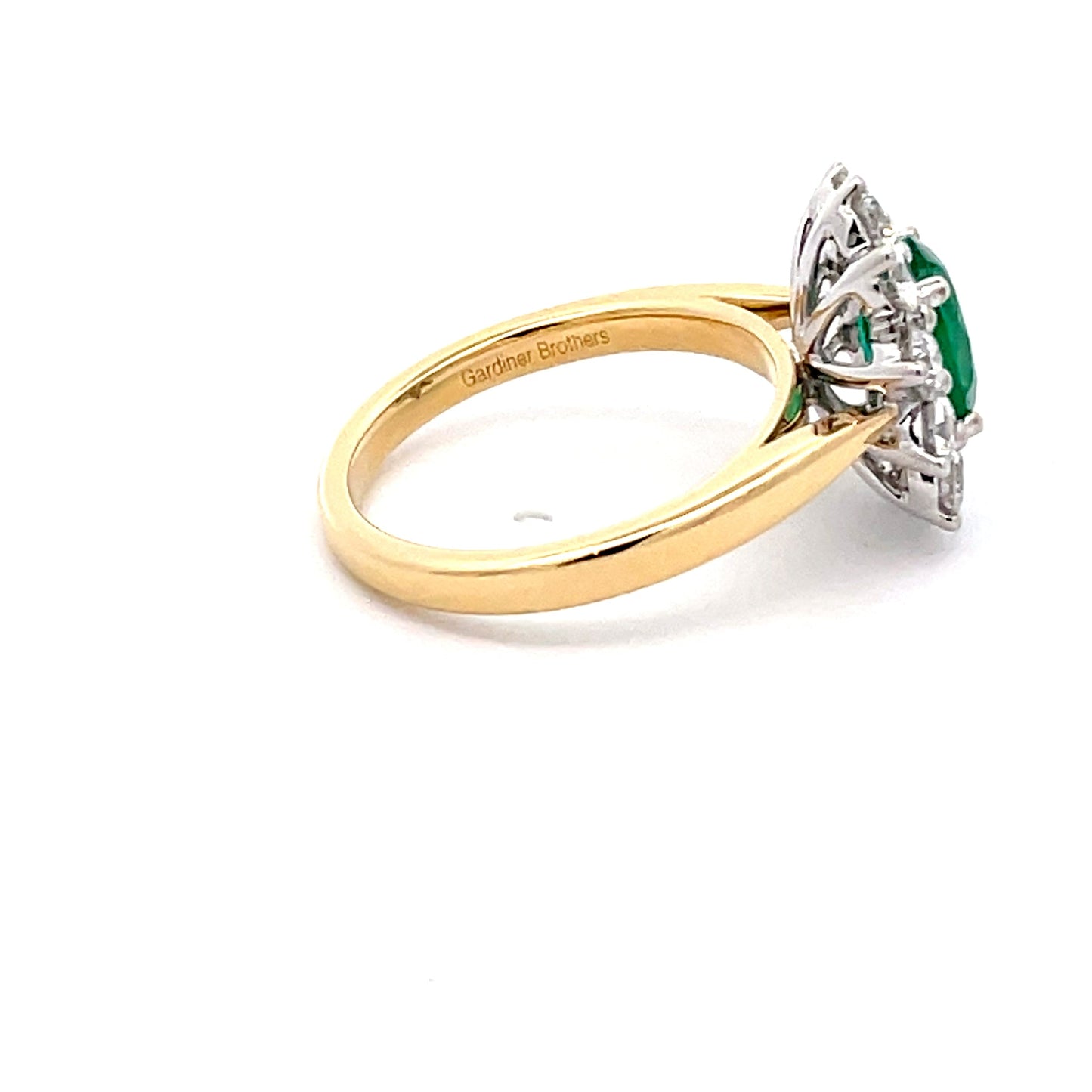 Oval Emerald AND ROUND BRILLIANT CUT DIAMOND CLUSTER STYLE RING Gardiner Brothers