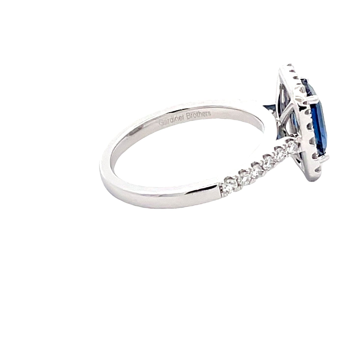 Octagonal Sapphire and round brilliant cut diamond halo cluster style ring Gardiner Brothers