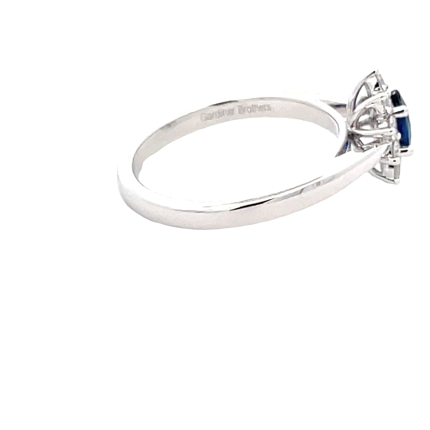Oval Sapphire and round brilliant cut diamond cluster style ring Gardiner Brothers