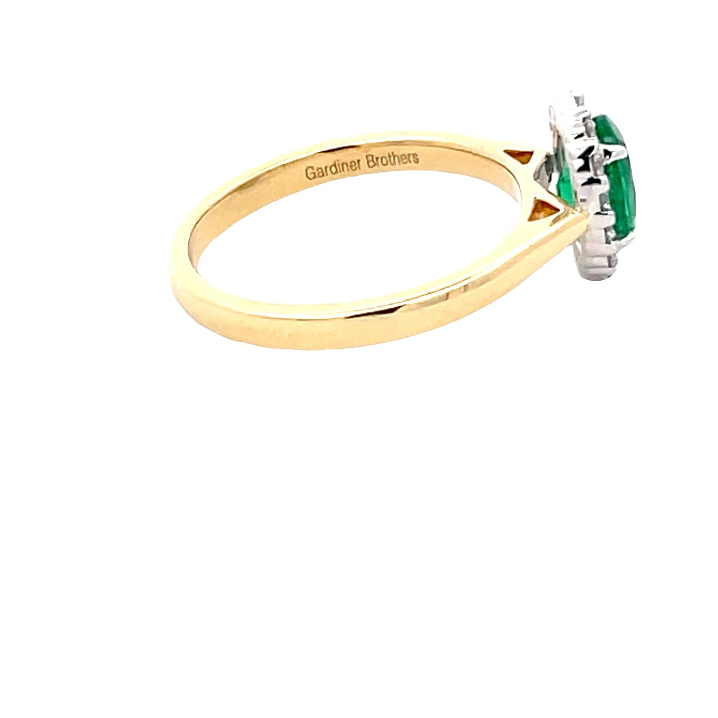 Oval Shaped Emerald and round brilliant cut diamond halo cluster ring Gardiner Brothers