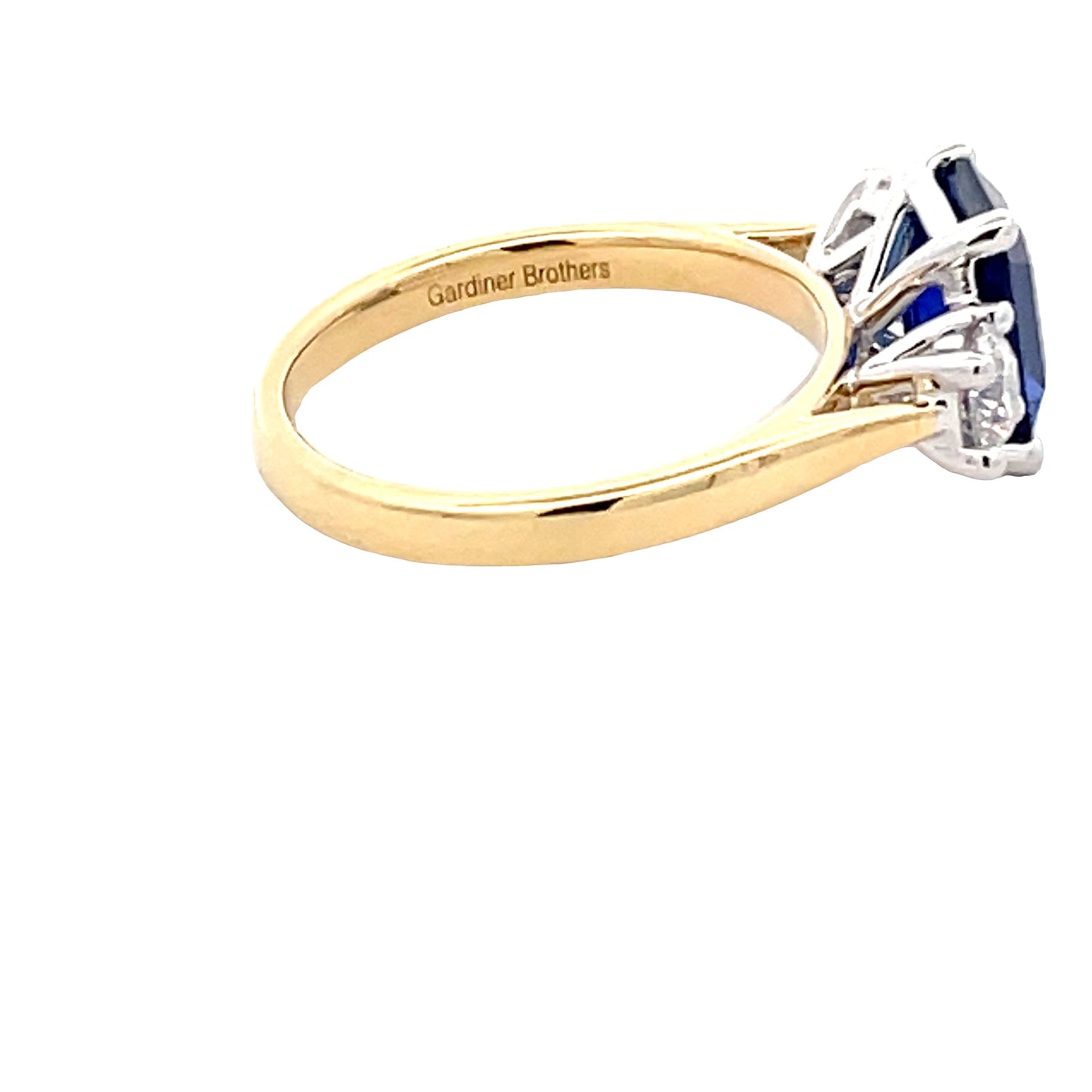 Octagonal Shaped Sapphire and round brilliant cut diamond 3 stone ring Gardiner Brothers