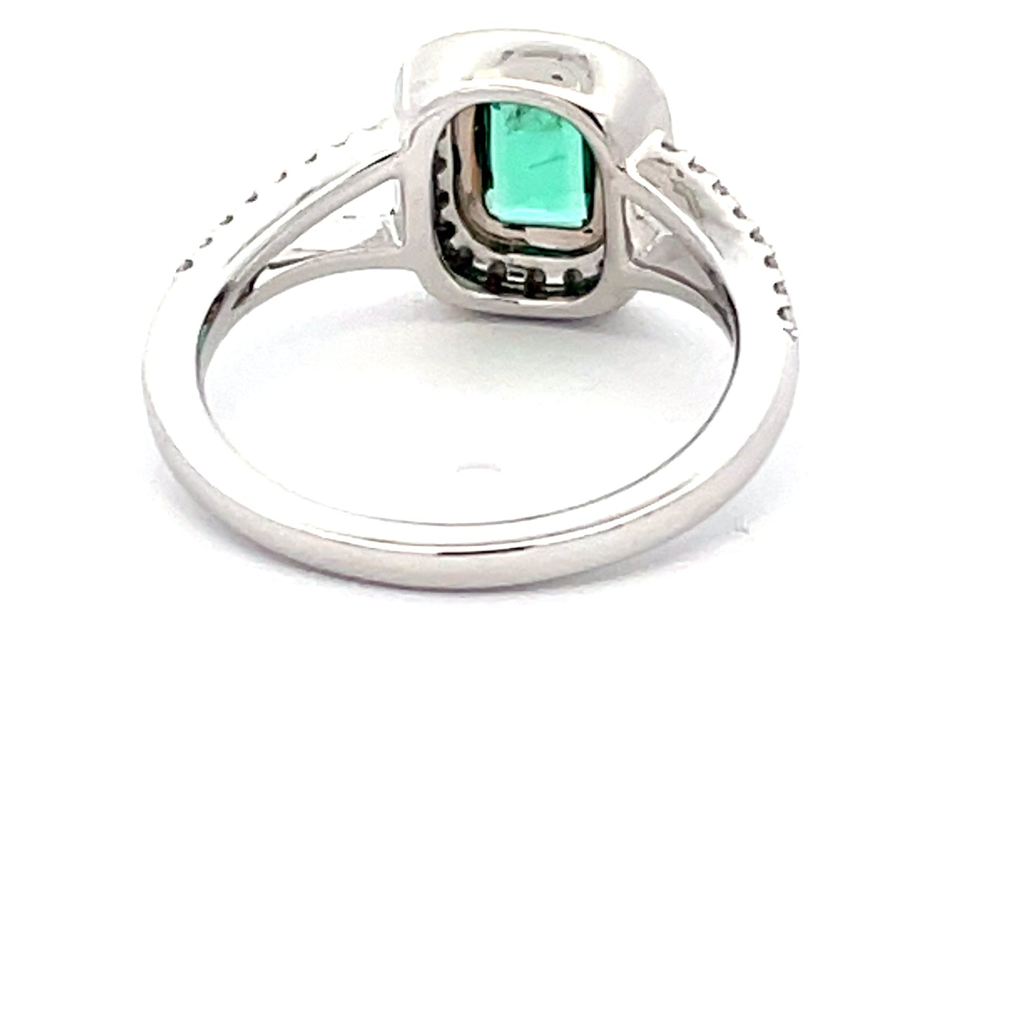 Octagonal emerald with round brilliant cut diamond halo cluster style ring Gardiner Brothers