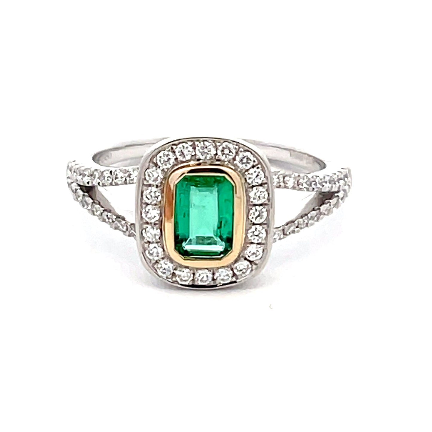 Octagonal emerald with round brilliant cut diamond halo cluster style ring Gardiner Brothers