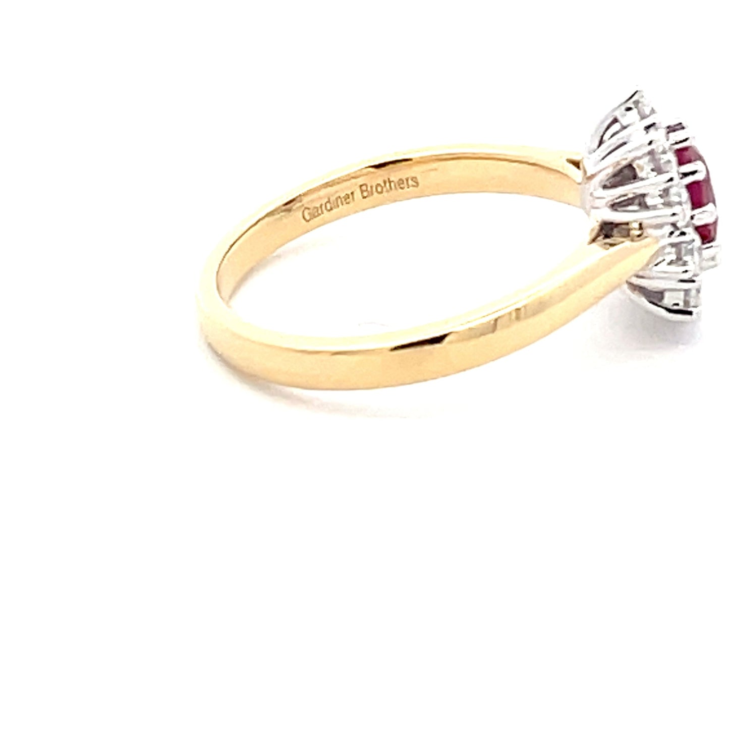 Oval Shaped Ruby and round brilliant cut diamond cluster style ring Gardiner Brothers