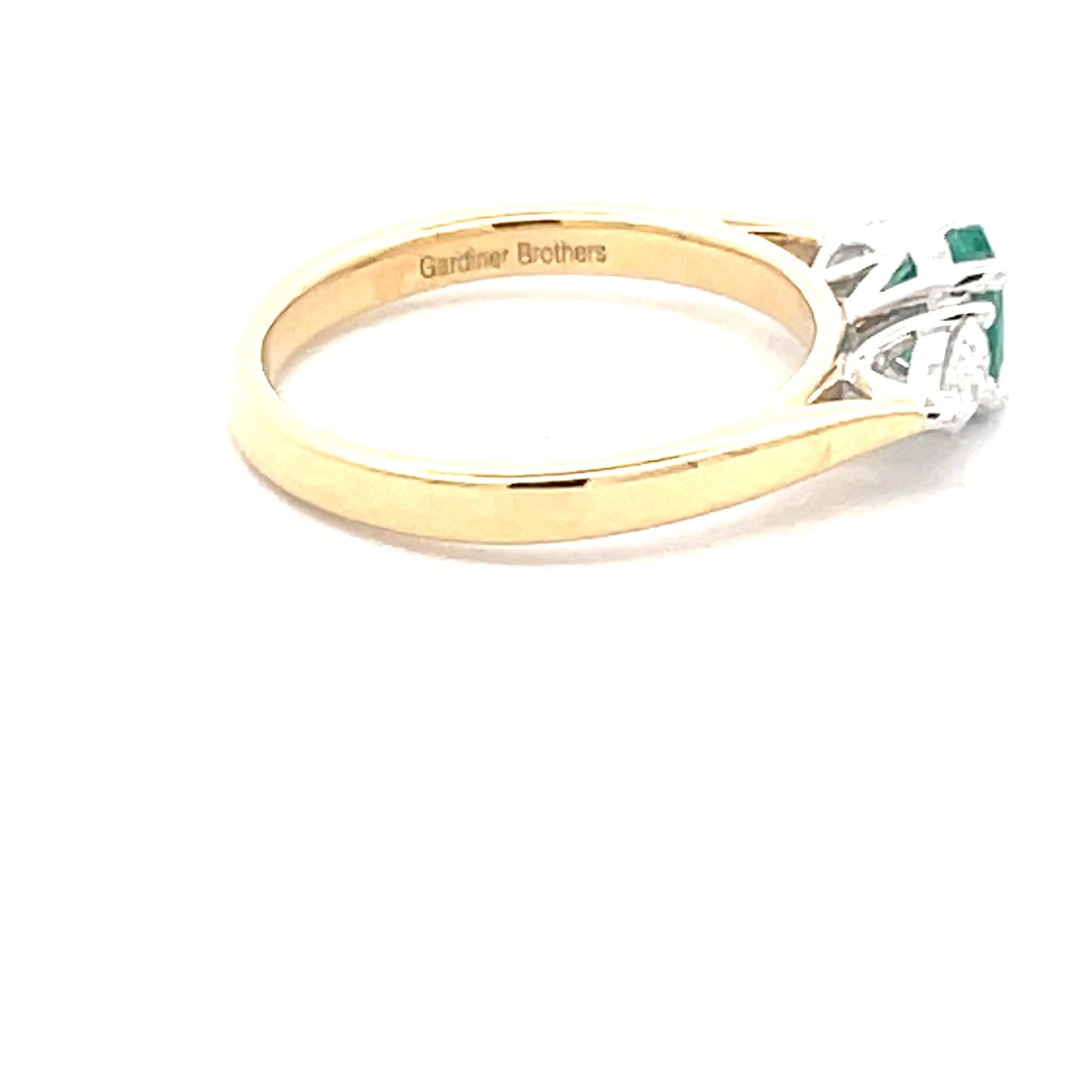 Oval Shaped Emerald and pear shaped diamond 3 stone ring Gardiner Brothers