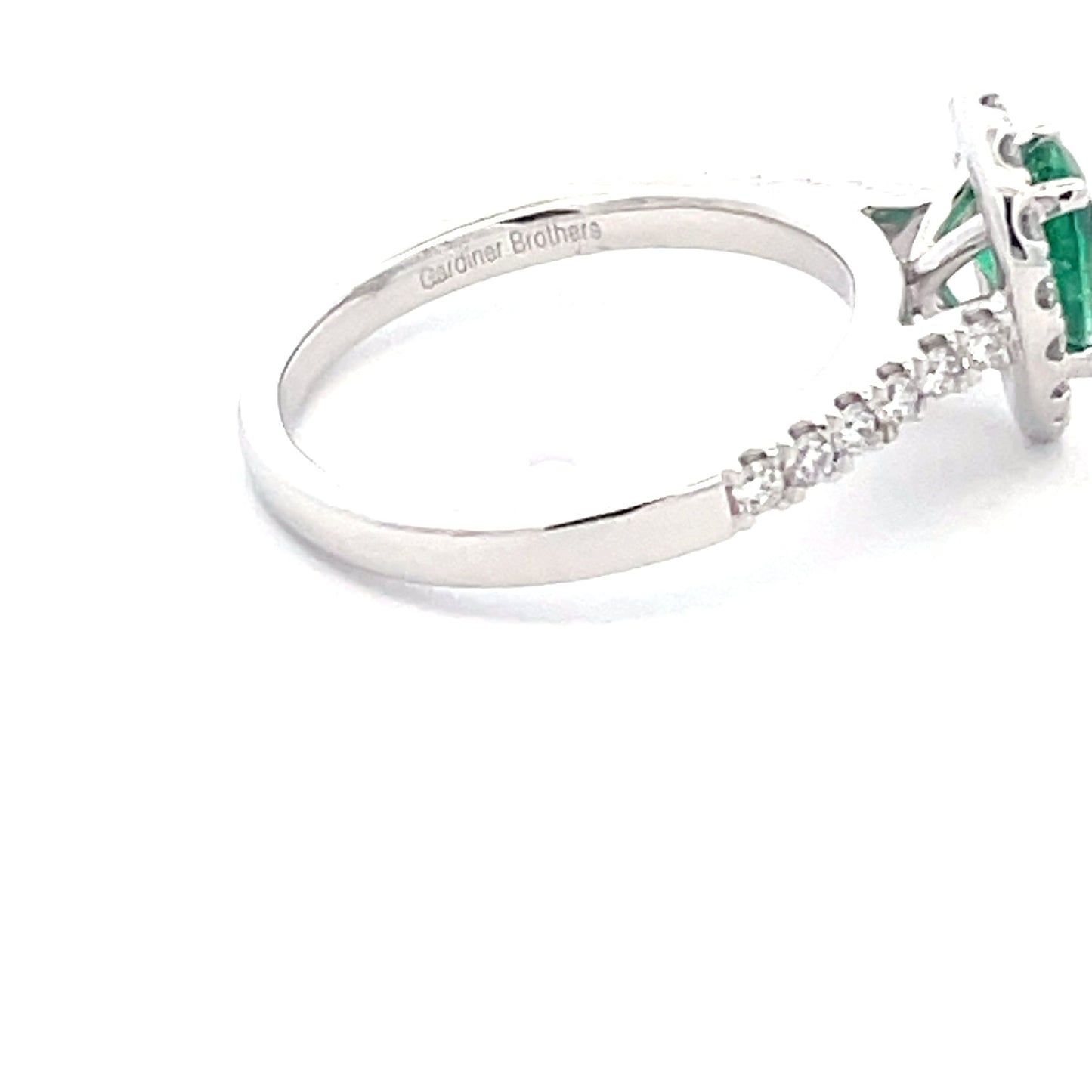 Pear Shaped emerald and round brilliant cut diamond halo cluster ring Gardiner Brothers