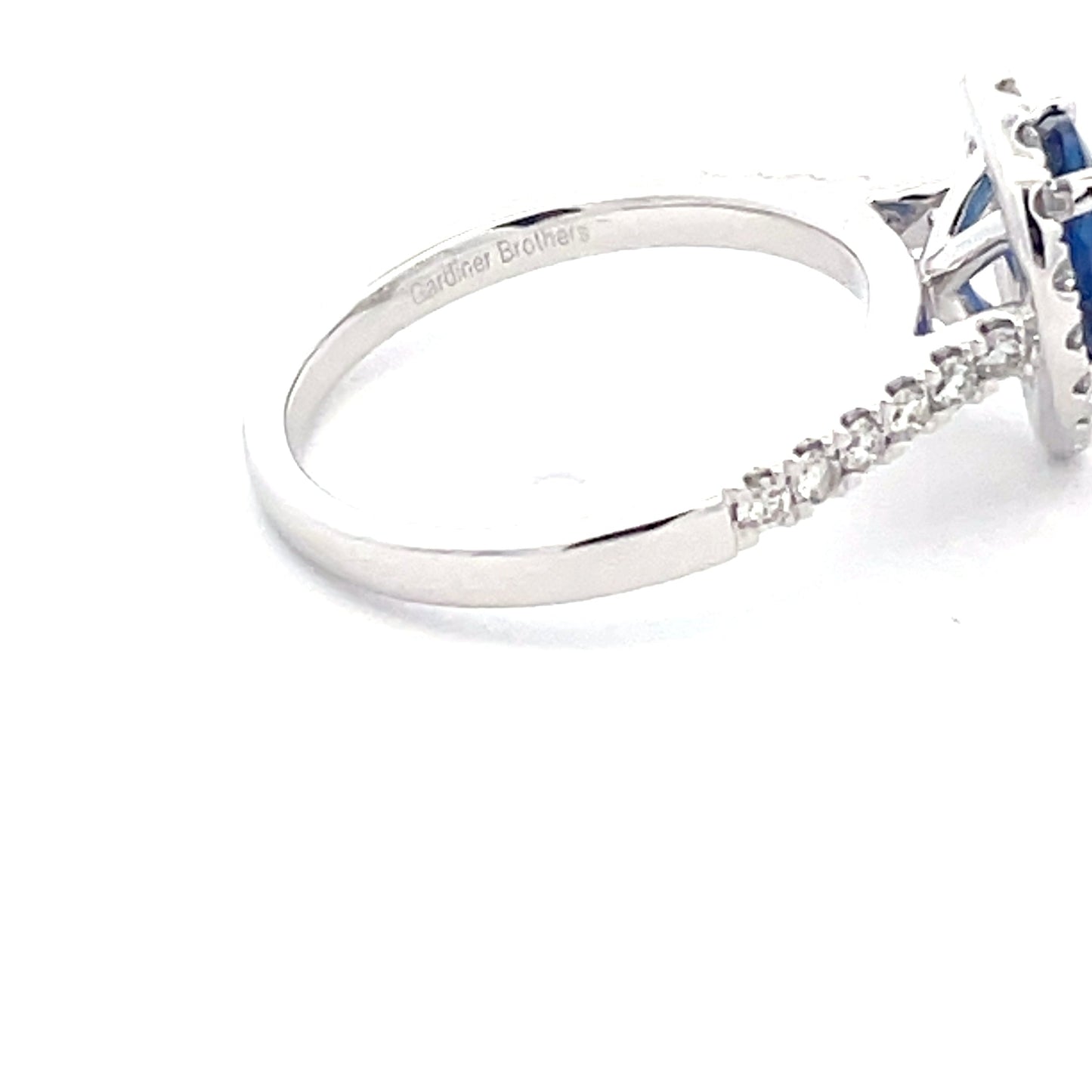 Pear Shaped Sapphire and round brilliant cut diamond halo cluster style ring Gardiner Brothers