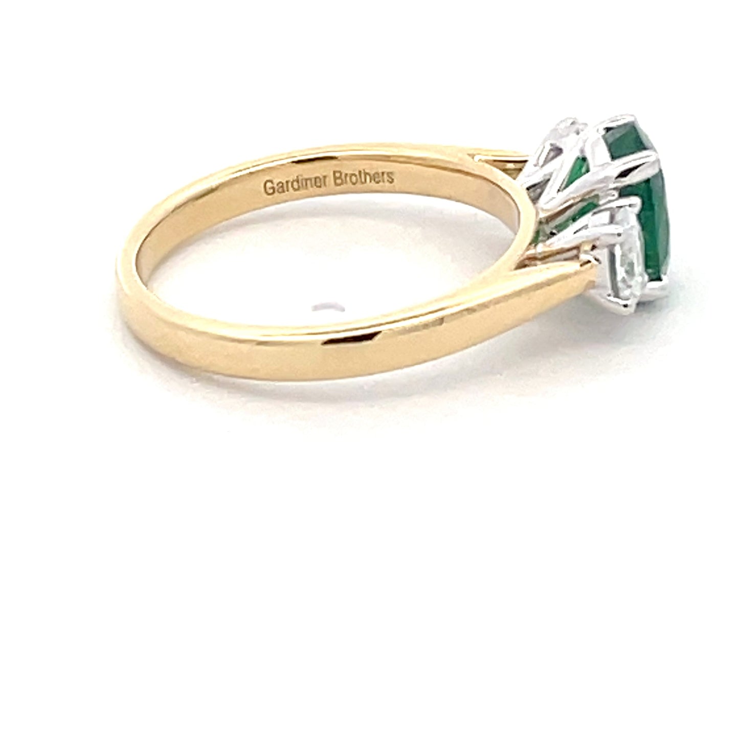 Oval Shaped Emerald and Oval Diamond 3 stone ring Gardiner Brothers