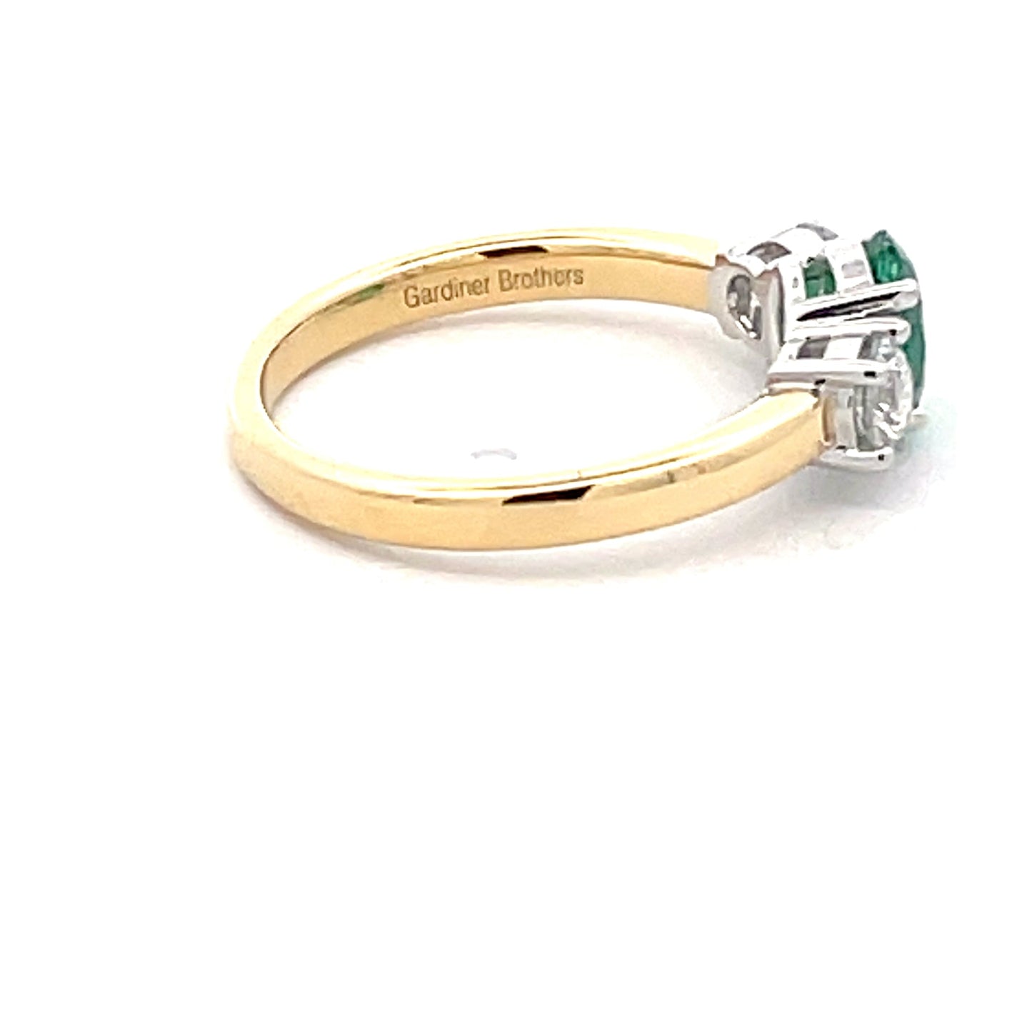 Oval Emerald and round brilliant cut diamond 3 stone ring Gardiner Brothers