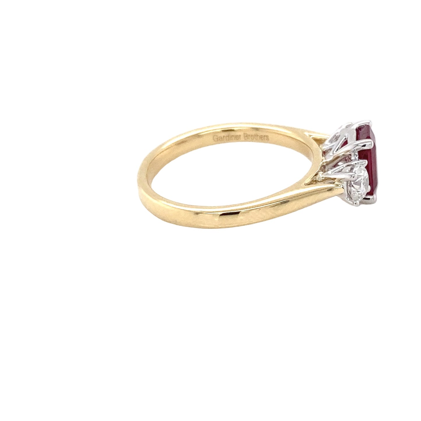 Octagonal Ruby and round brilliant cut diamond 3 stone ring Gardiner Brothers
