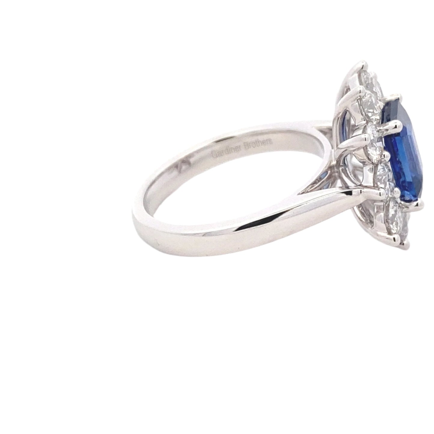 Octagonal shaped sapphire and round brilliant cut diamond cluster style ring Gardiner Brothers