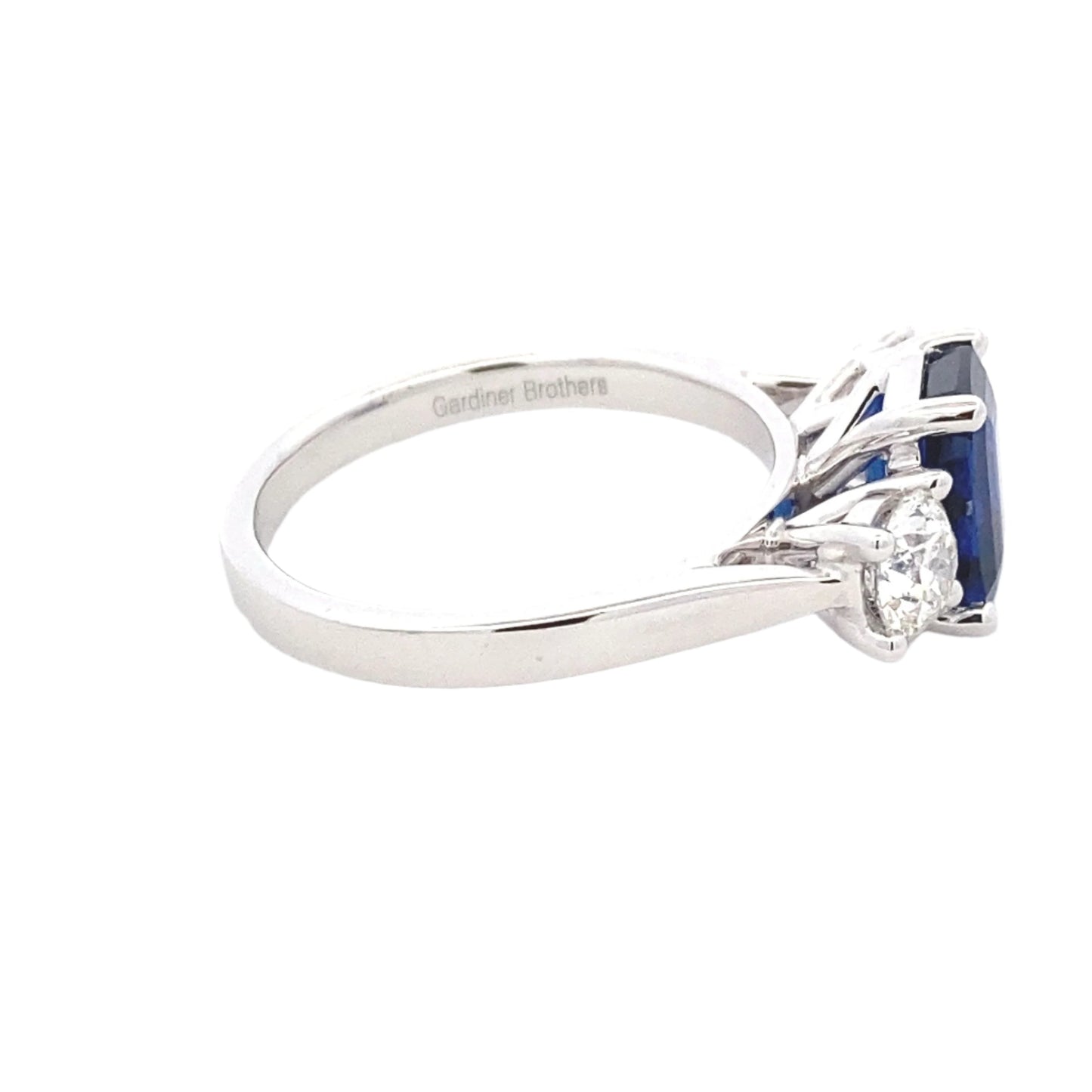 Octagonal Shaped Sapphire and round brilliant cut diamond 3 stone ring Gardiner Brothers