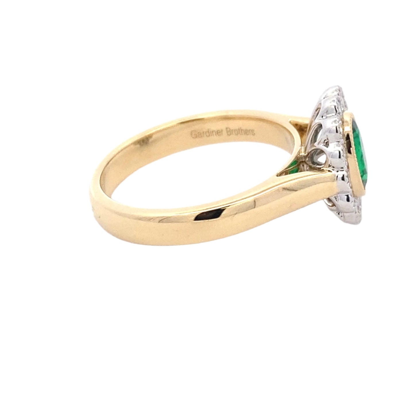 Oval emerald and round brilliant cut diamond vintage style cluster ring Gardiner Brothers