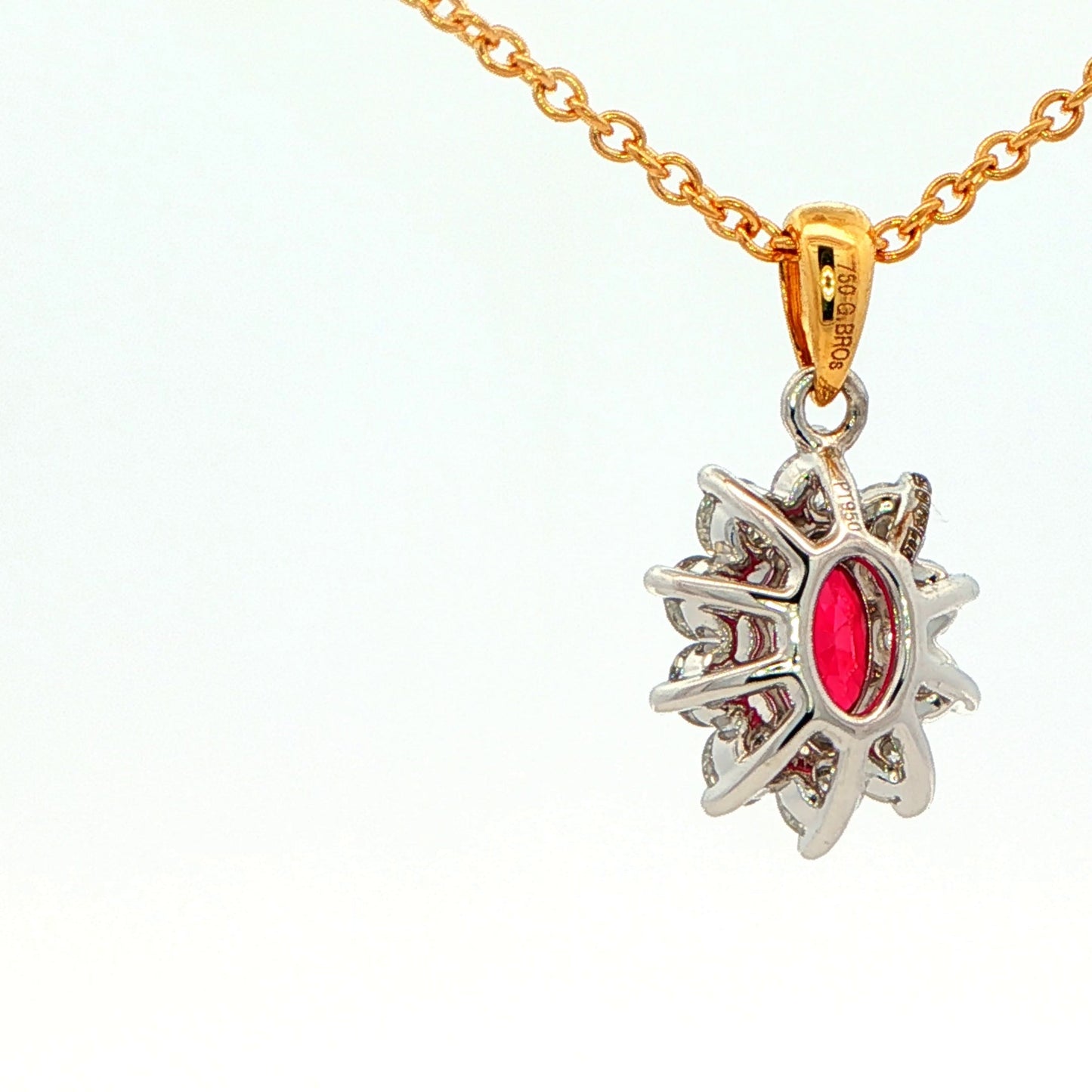 Oval shaped ruby and round brilliant cut diamond cluster style pendant