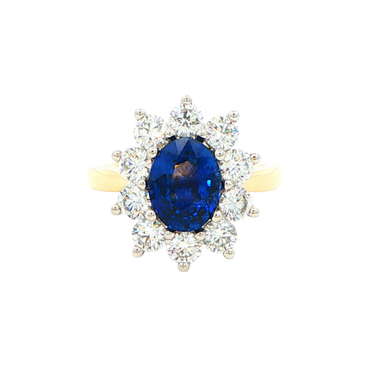 Oval Sapphire and round brilliant cut diamond cluster ring