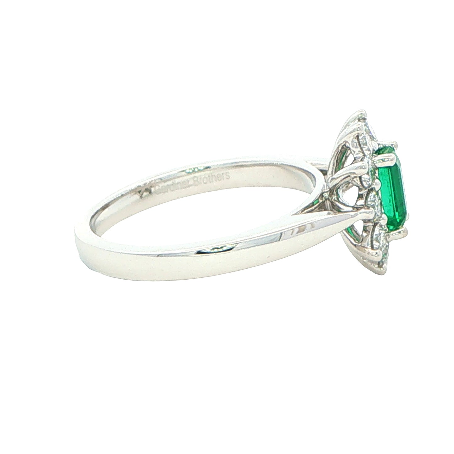 Octagonal shaped emerald and round brilliant cut diamond cluster style ring Gardiner Brothers