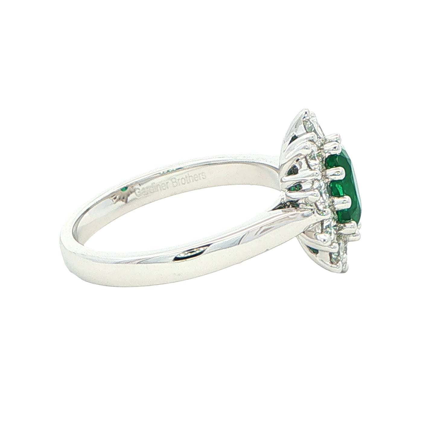 Emerald and round brilliant cut diamond cluster style ring Gardiner Brothers