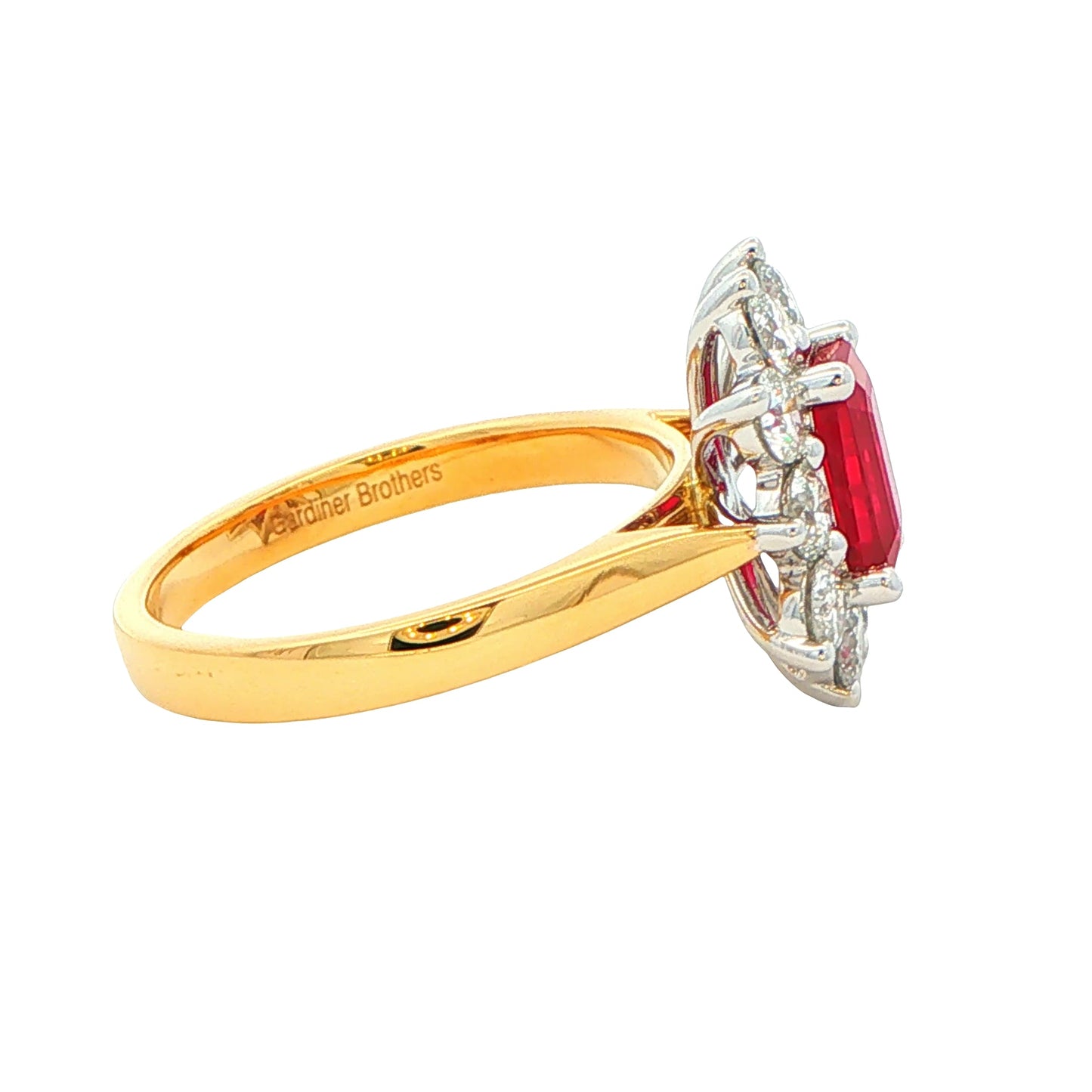 Octagonal shaped ruby and round brilliant cut diamond cluster style ring Gardiner Brothers