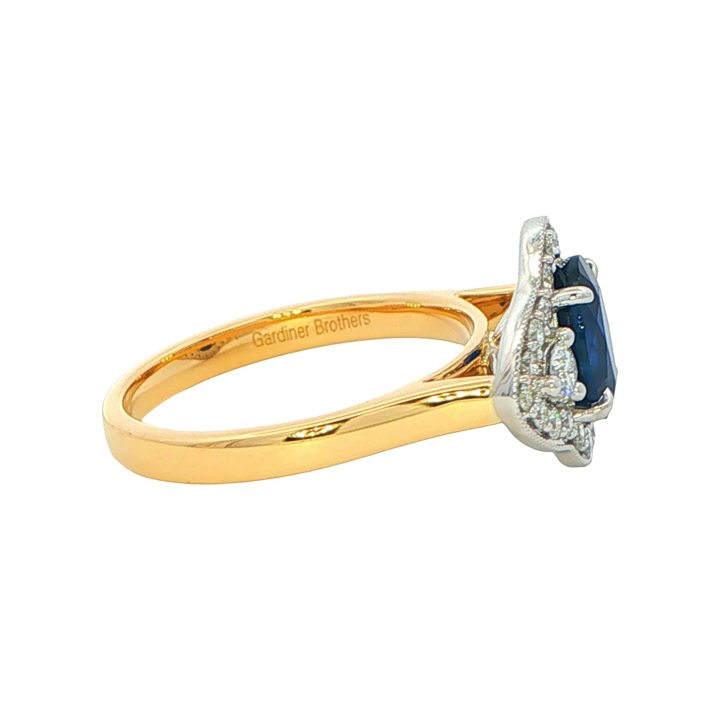 Oval Sapphire and round brilliant cut diamond fancy halo style ring Gardiner Brothers