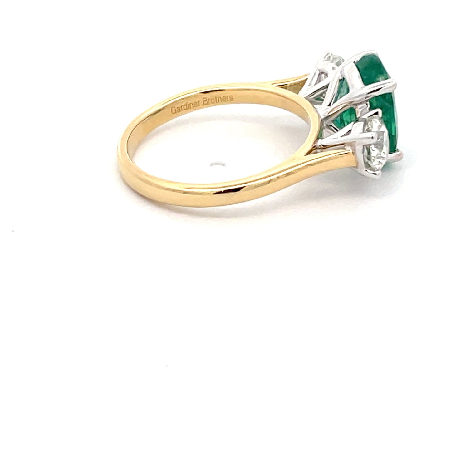Emerald and round brilliant cut diamond 3 stone ring Gardiner Brothers