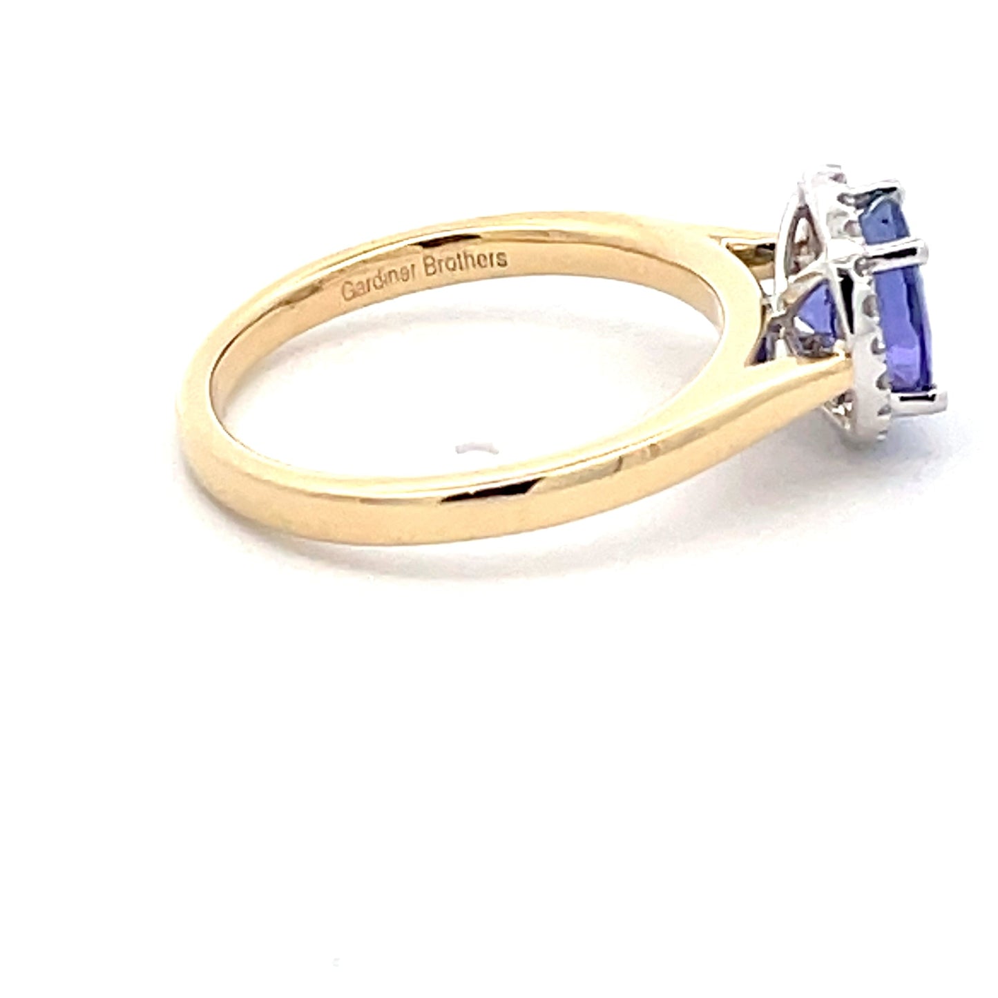 Tanzanite and round brilliant cut diamond halo ring Gardiner Brothers