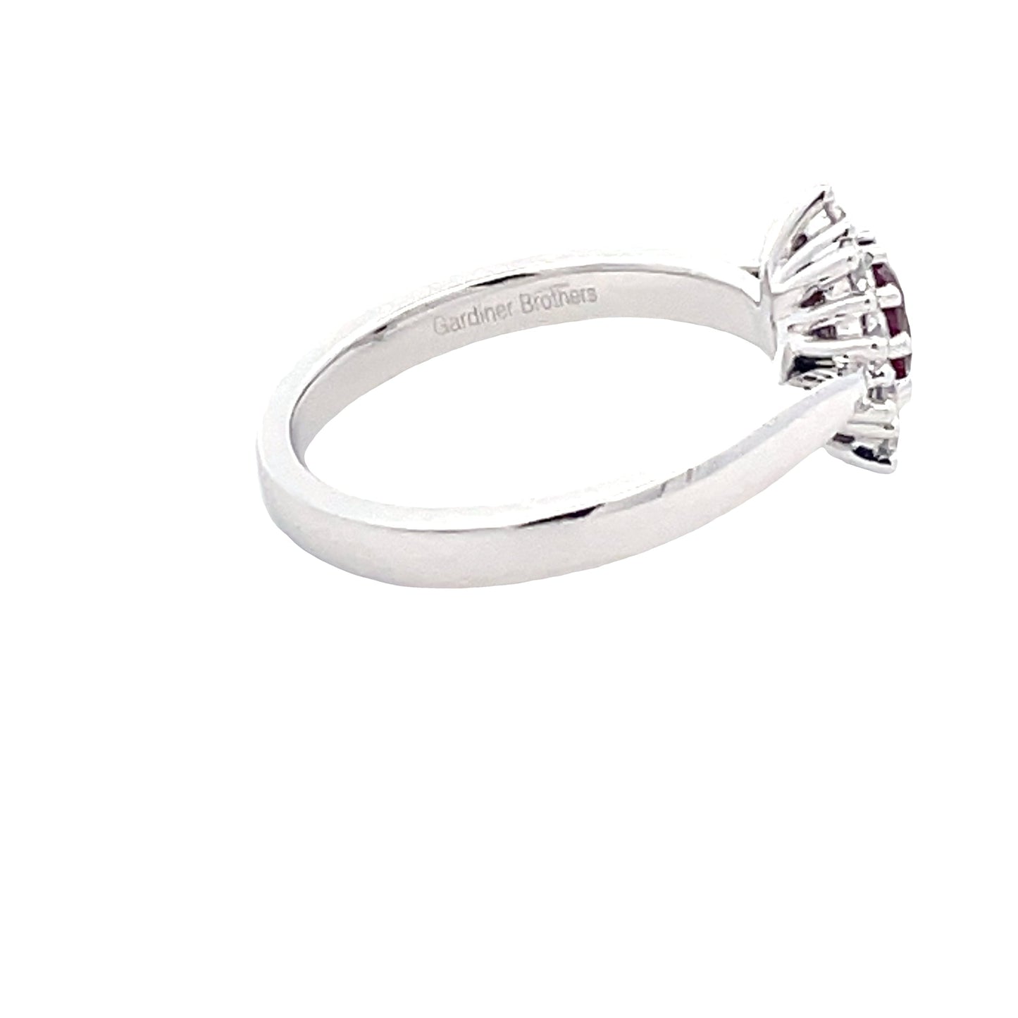 Oval Ruby and round brilliant cut diamond cluster style ring
