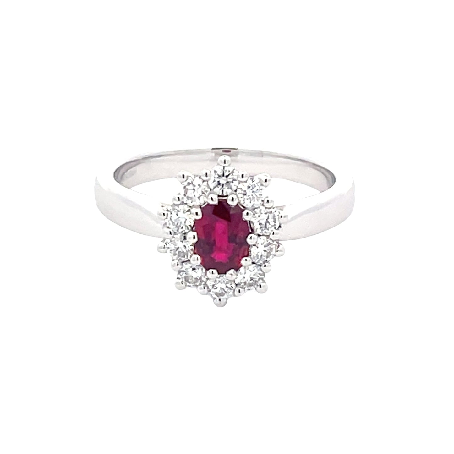 Oval Ruby and round brilliant cut diamond cluster style ring