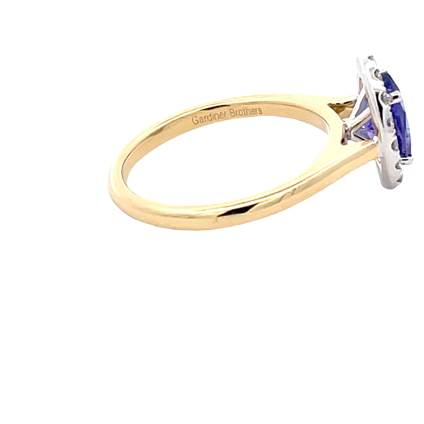 Oval Tanzanite and round brilliant cut diamond halo ring  Gardiner Brothers   