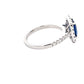 Octagonal Sapphire and round brilliant cut diamond halo cluster style ring  Gardiner Brothers   