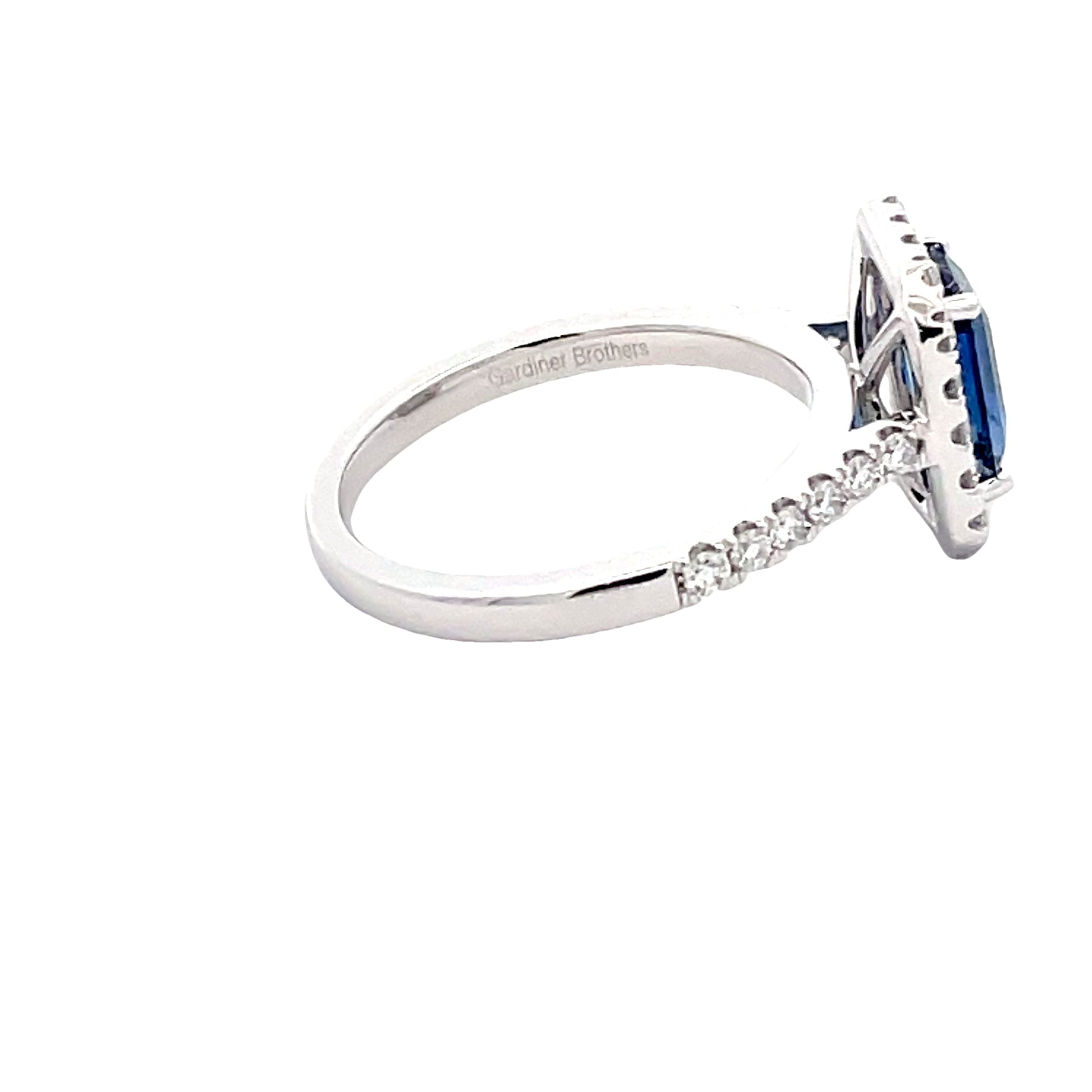 Octagonal Sapphire and round brilliant cut diamond halo cluster style ring  Gardiner Brothers   