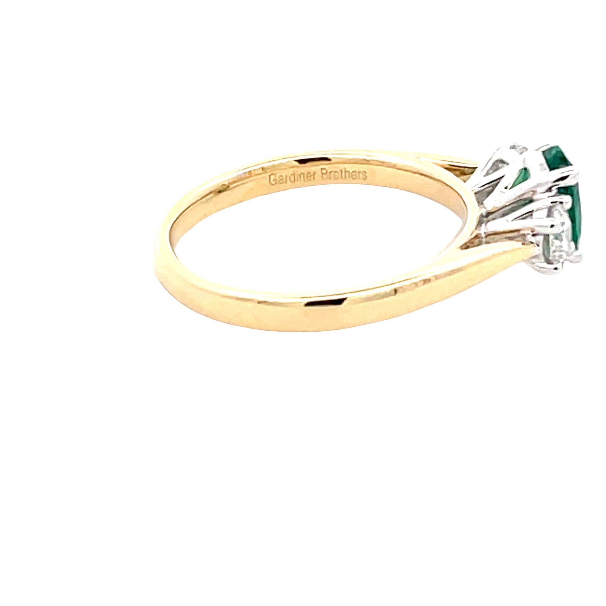 Oval Emerald and round brilliant cut diamond 3 stone ring  gardiner-brothers   