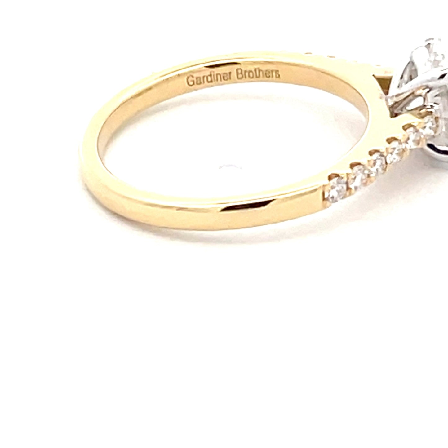 Yellow Gold Oval Shaped Diamond Solitaire Ring with round brilliant cut diamond set shoulders - 1.28cts Gardiner Brothers