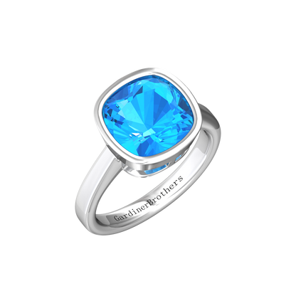 Nova cushion shaped Swiss Blue Topaz ring set in a plain bezel setting Gardiner Brothers White Gold
