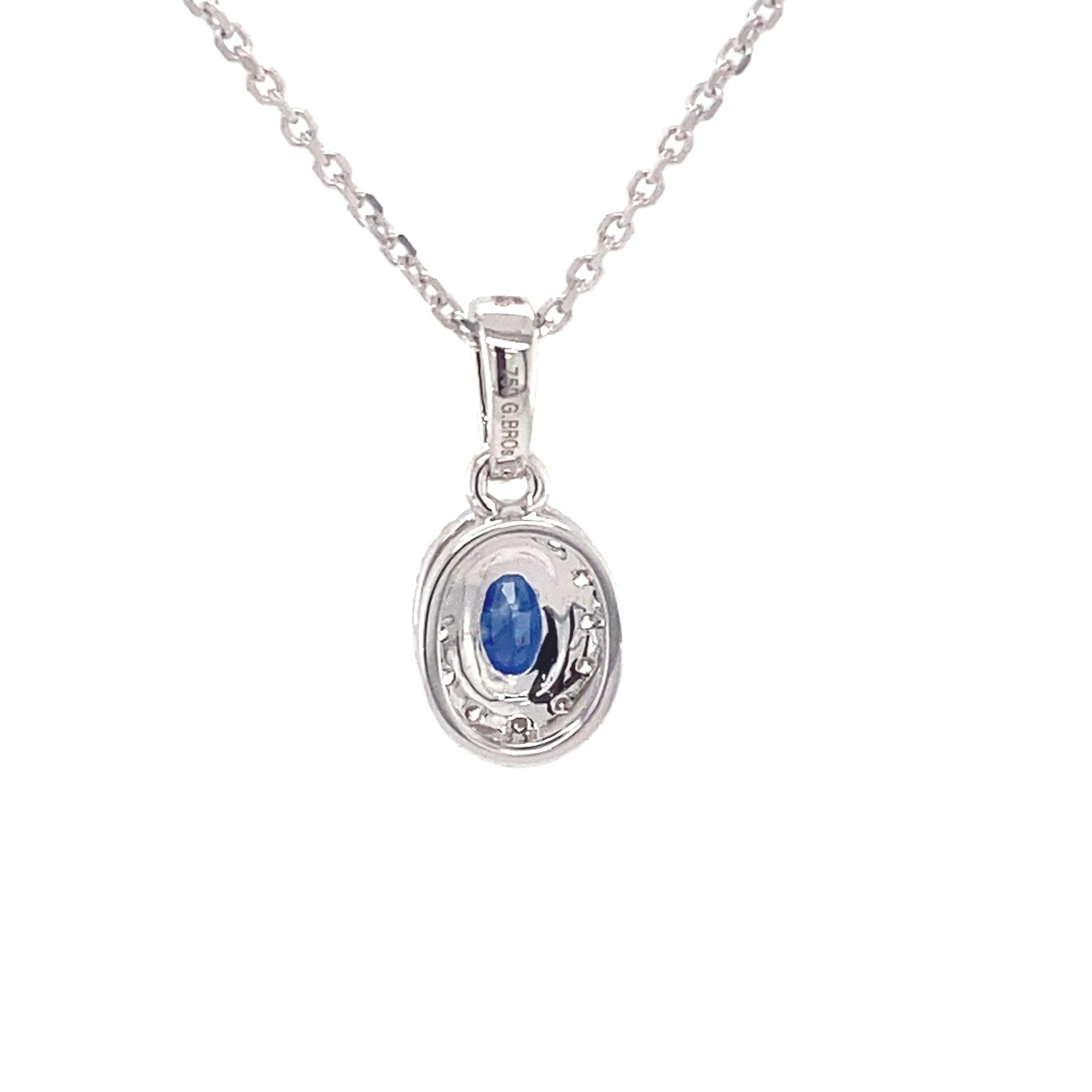 Oval sapphire and round brilliant cut diamond halo style pendant  Gardiner Brothers   