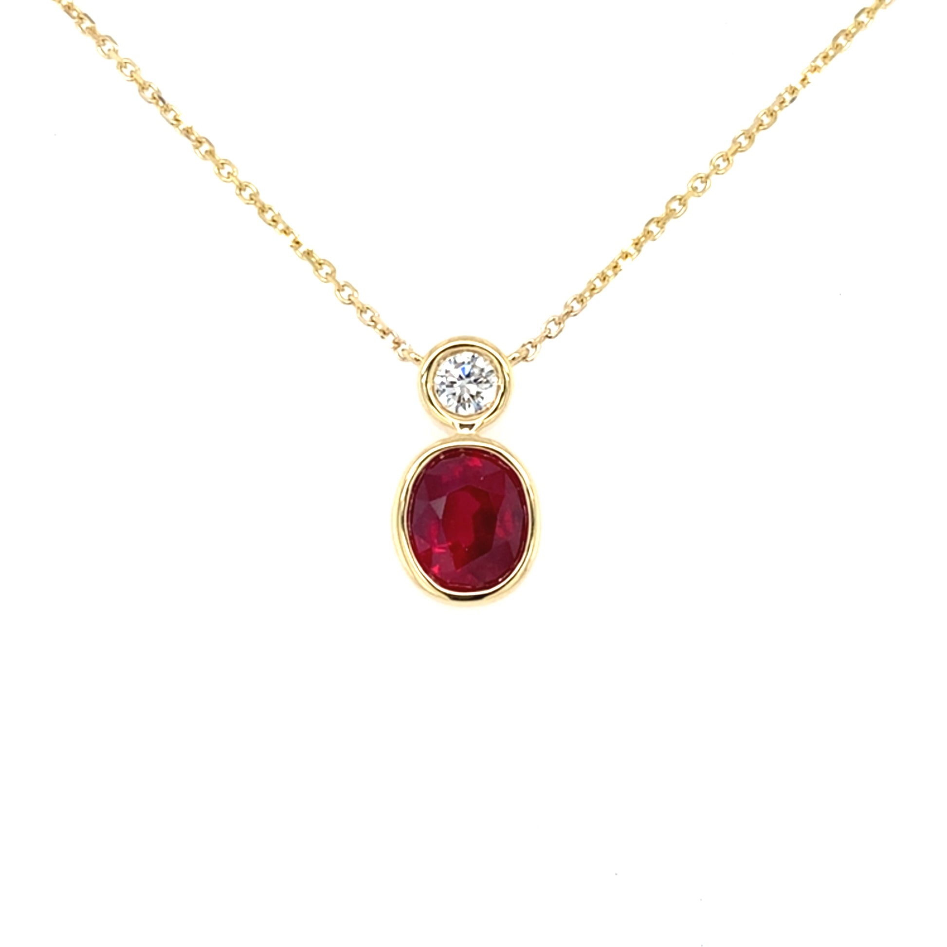 Oval Ruby and Round Brilliant cut diamond, rub-over drop style pendant Gardiner Brothers