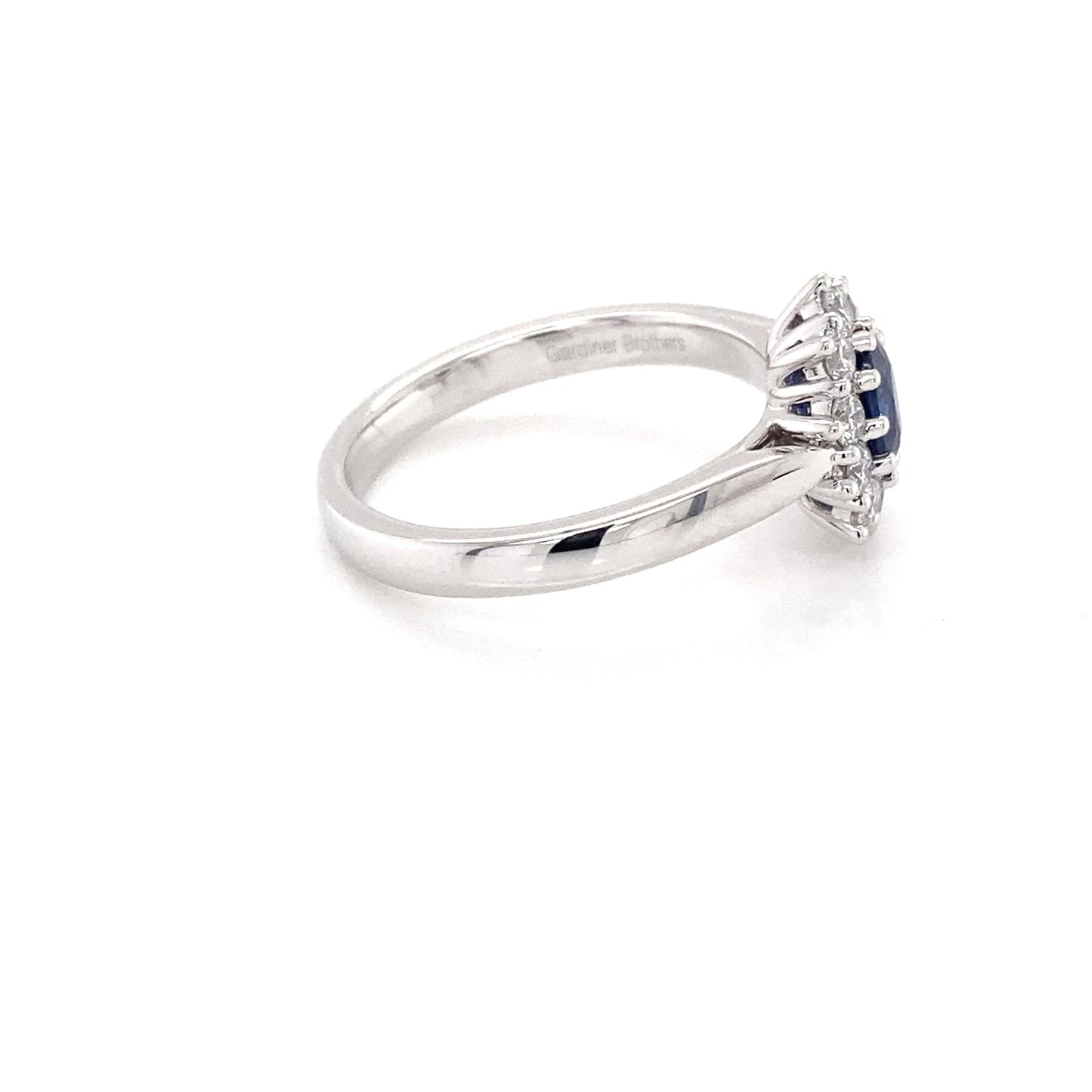 Oval Sapphire and round brilliant cut diamond cluster ring Gardiner Brothers