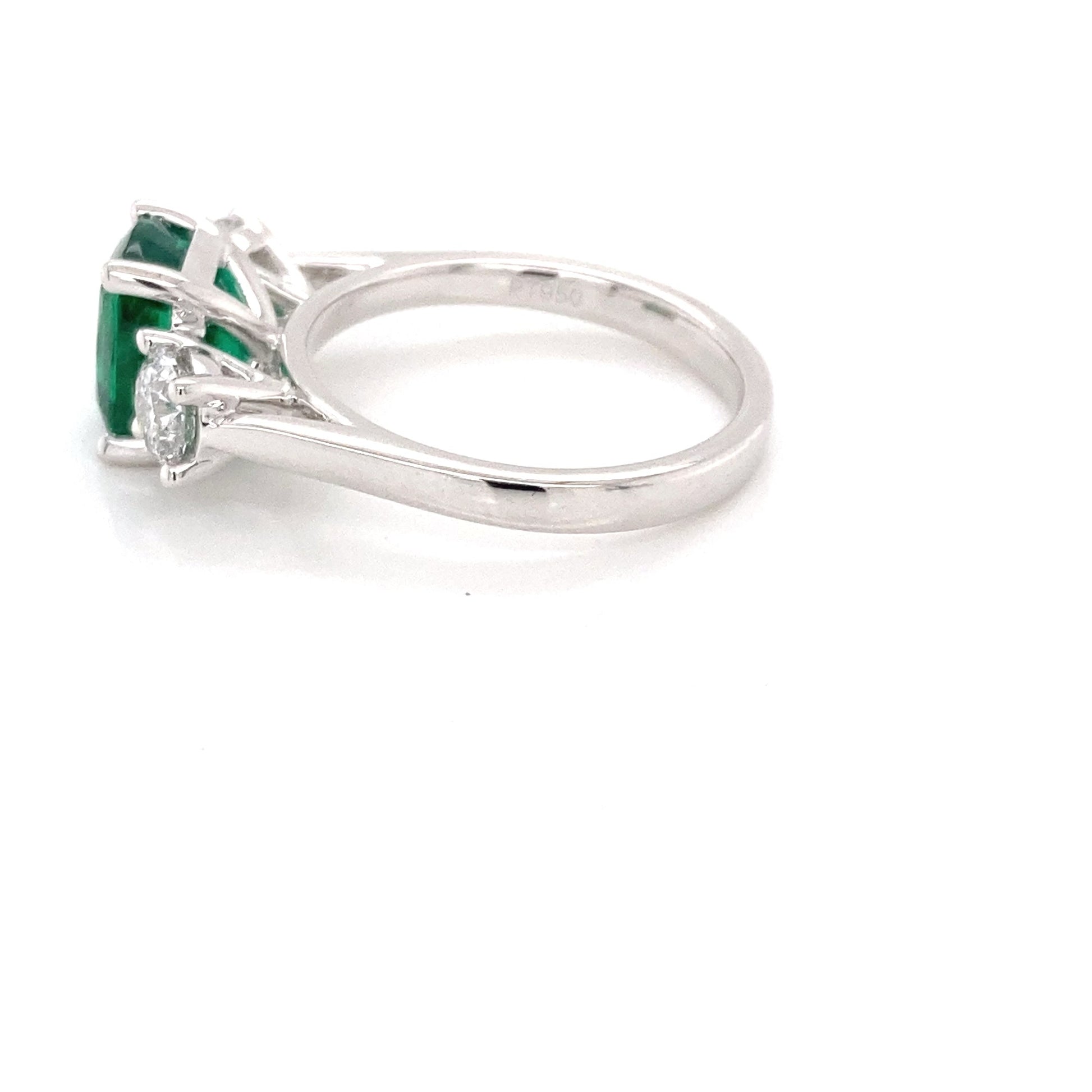 Cushion shaped emerald and round brilliant cut diamond 3 stone ring Gardiner Brothers