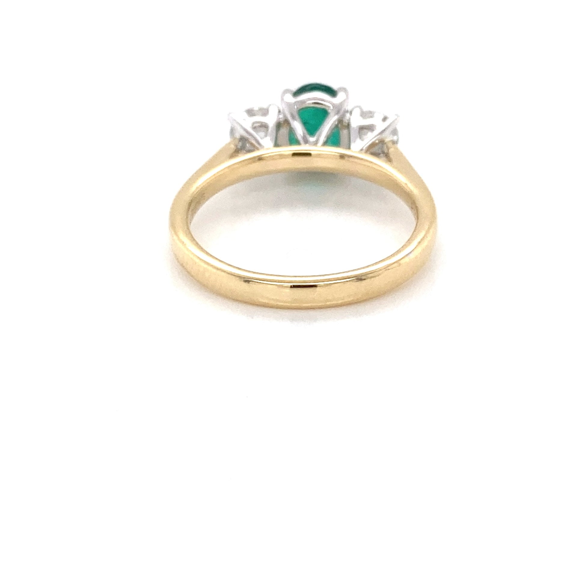 Oval Shaped Emerald and round brilliant cut diamond 3 stone ring Gardiner Brothers