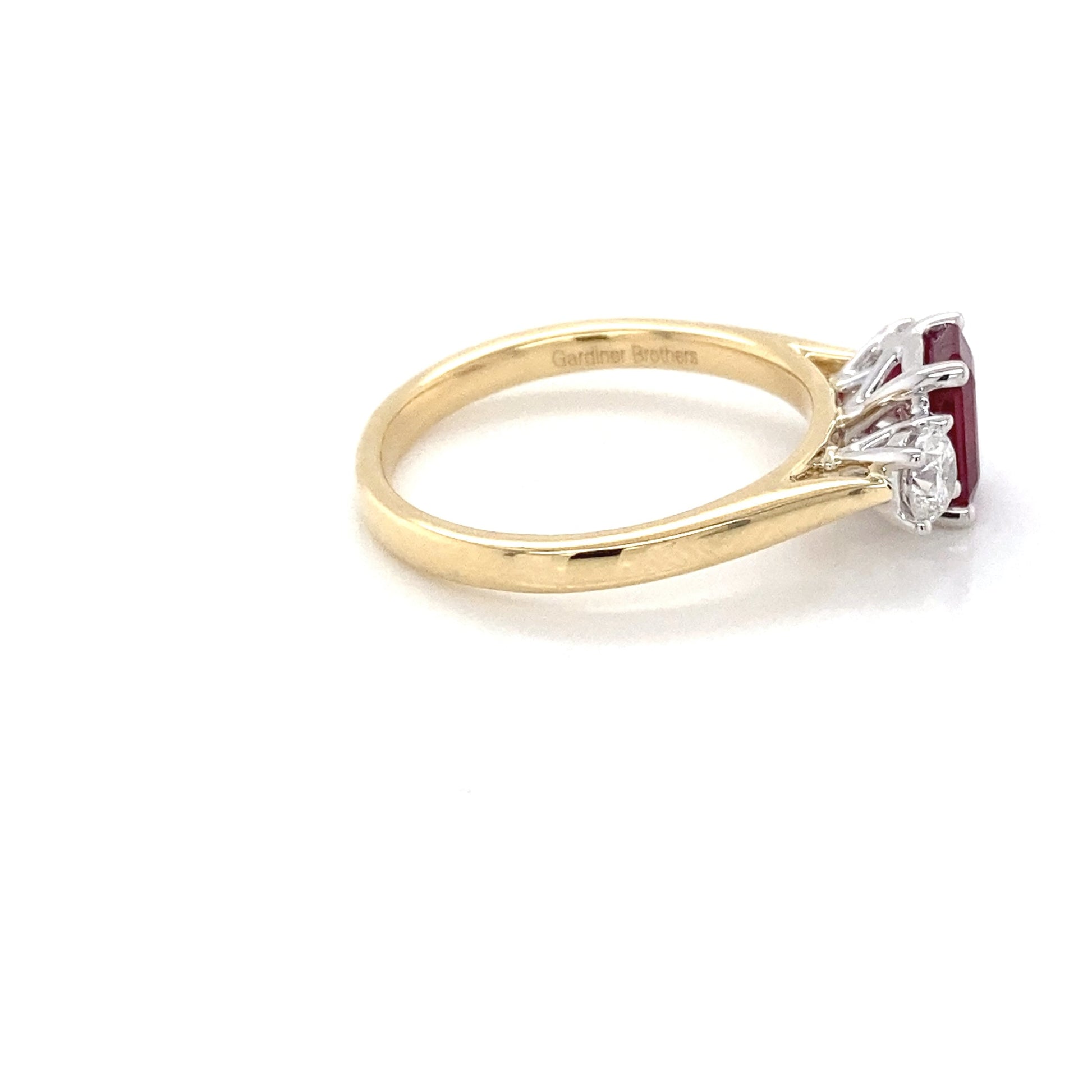 Octagonal Ruby and round brilliant cut diamond 3 stone ring Gardiner Brothers