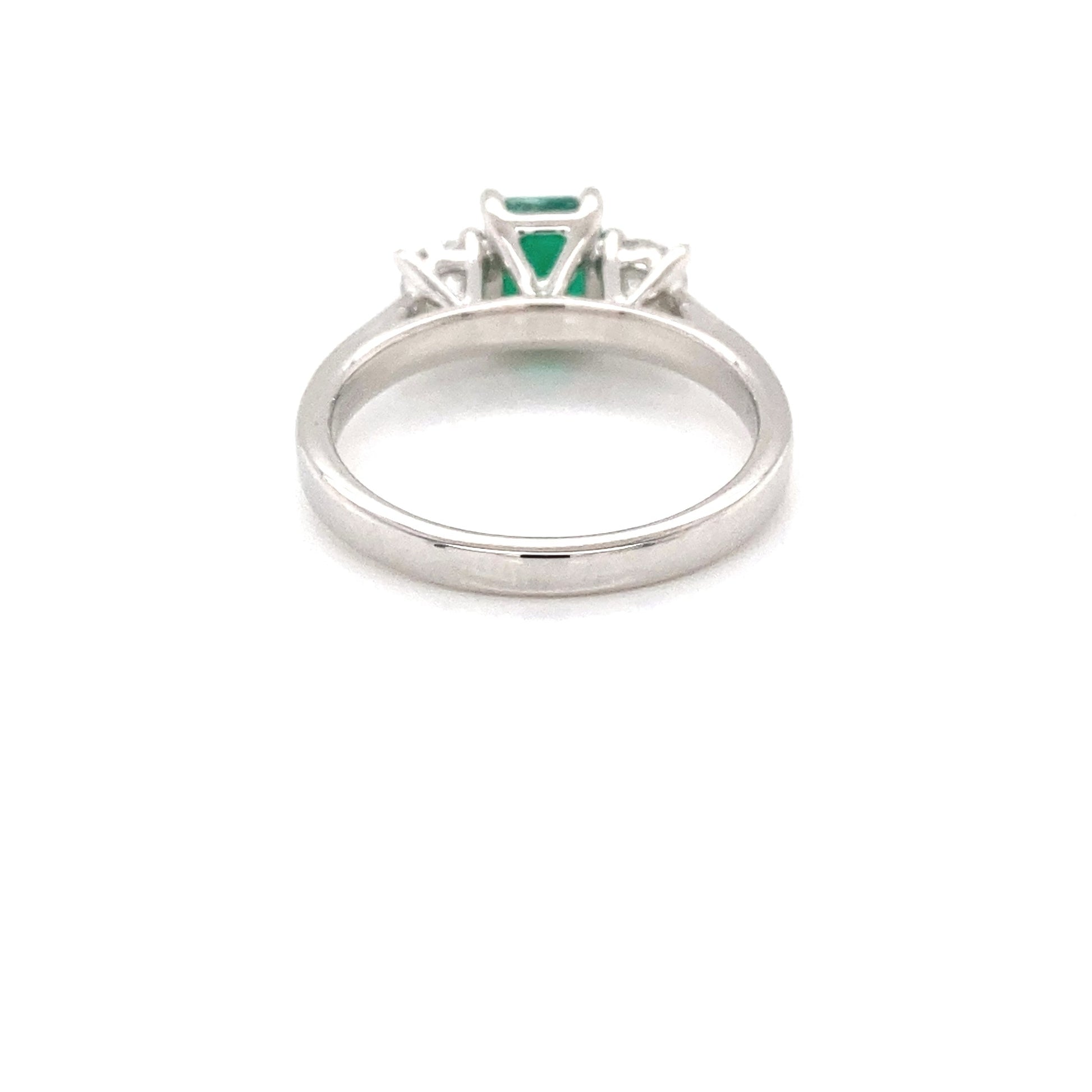 Octagonal shaped emerald and round brilliant cut diamond 3 stone ring Gardiner Brothers