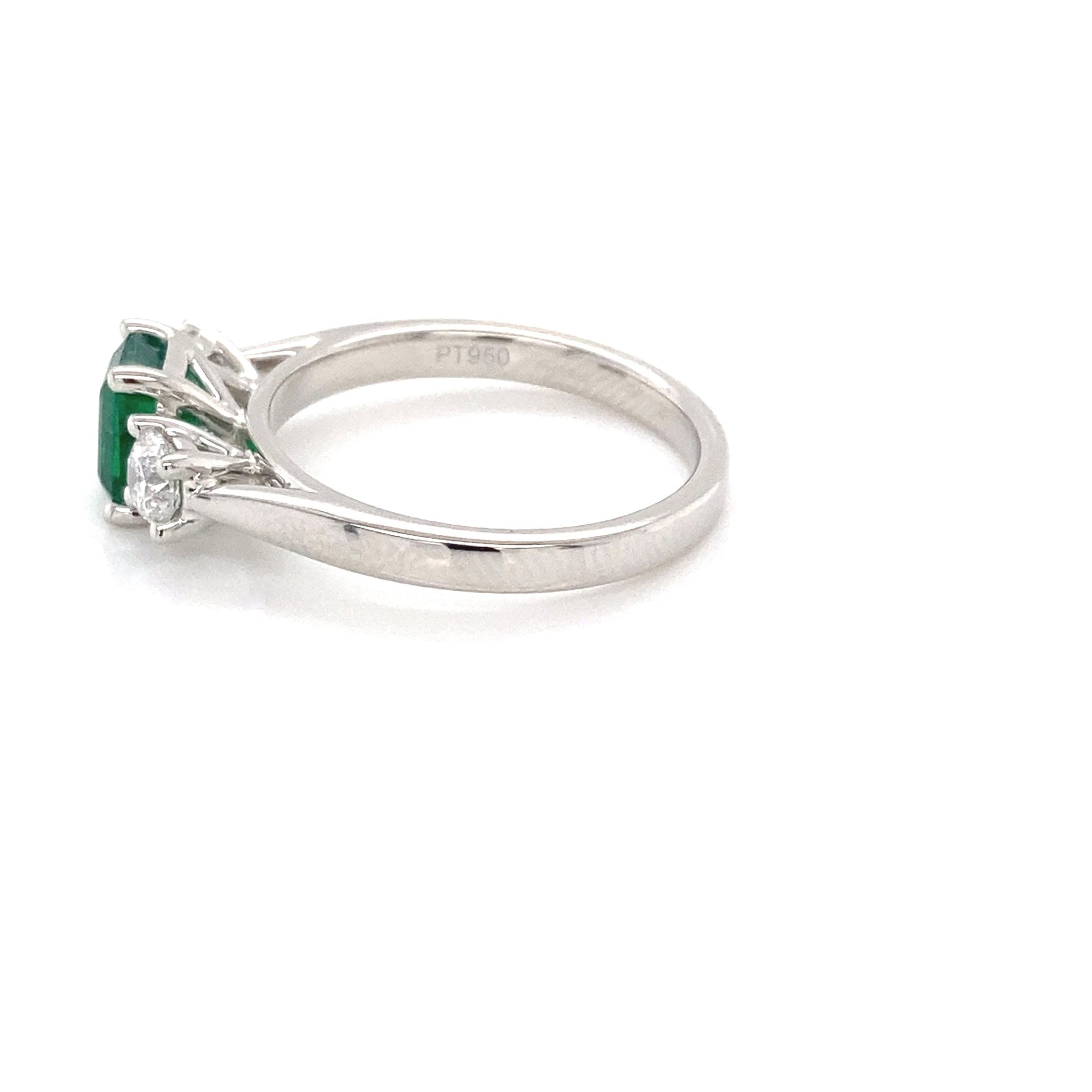 Octagonal shaped emerald and round brilliant cut diamond 3 stone ring Gardiner Brothers