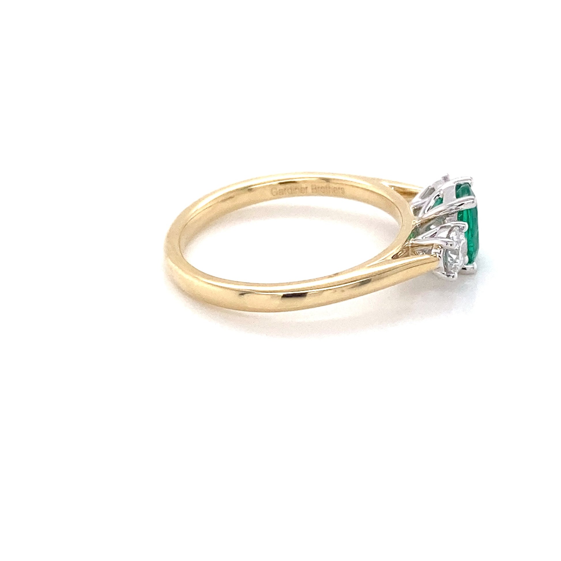 Cushion Shaped emerald and round brilliant cut diamond 3 stone ring Gardiner Brothers