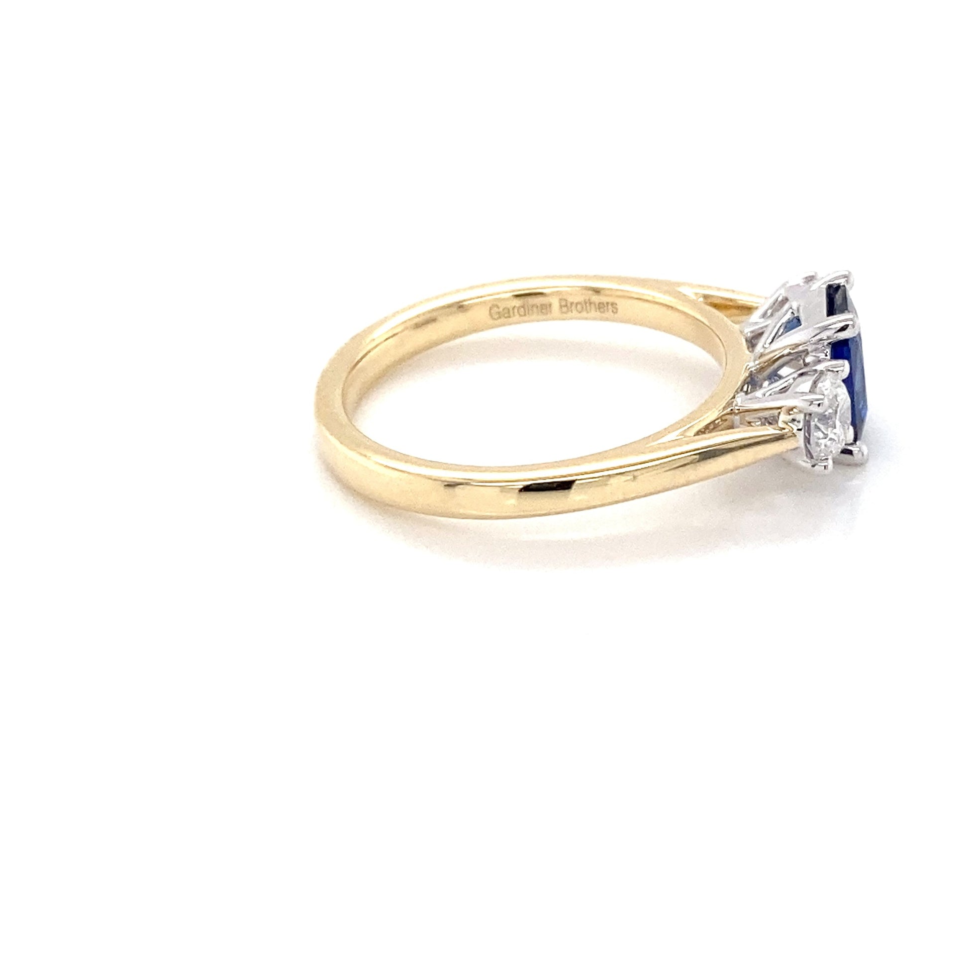 Cushion Shaped Sapphire and round brilliant cut diamond 3 stone ring Gardiner Brothers