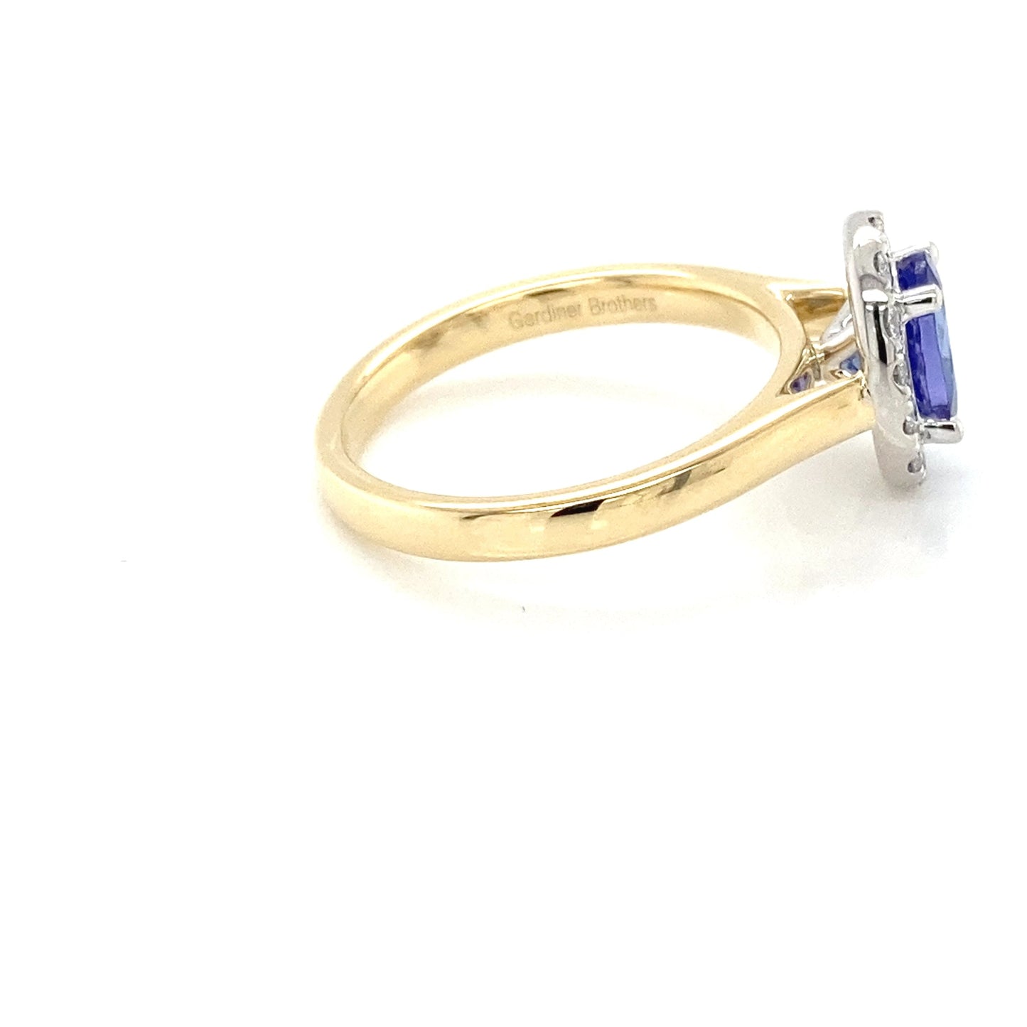 Oval Shaped Tanzanite and round brilliant cut diamond halo ring Gardiner Brothers