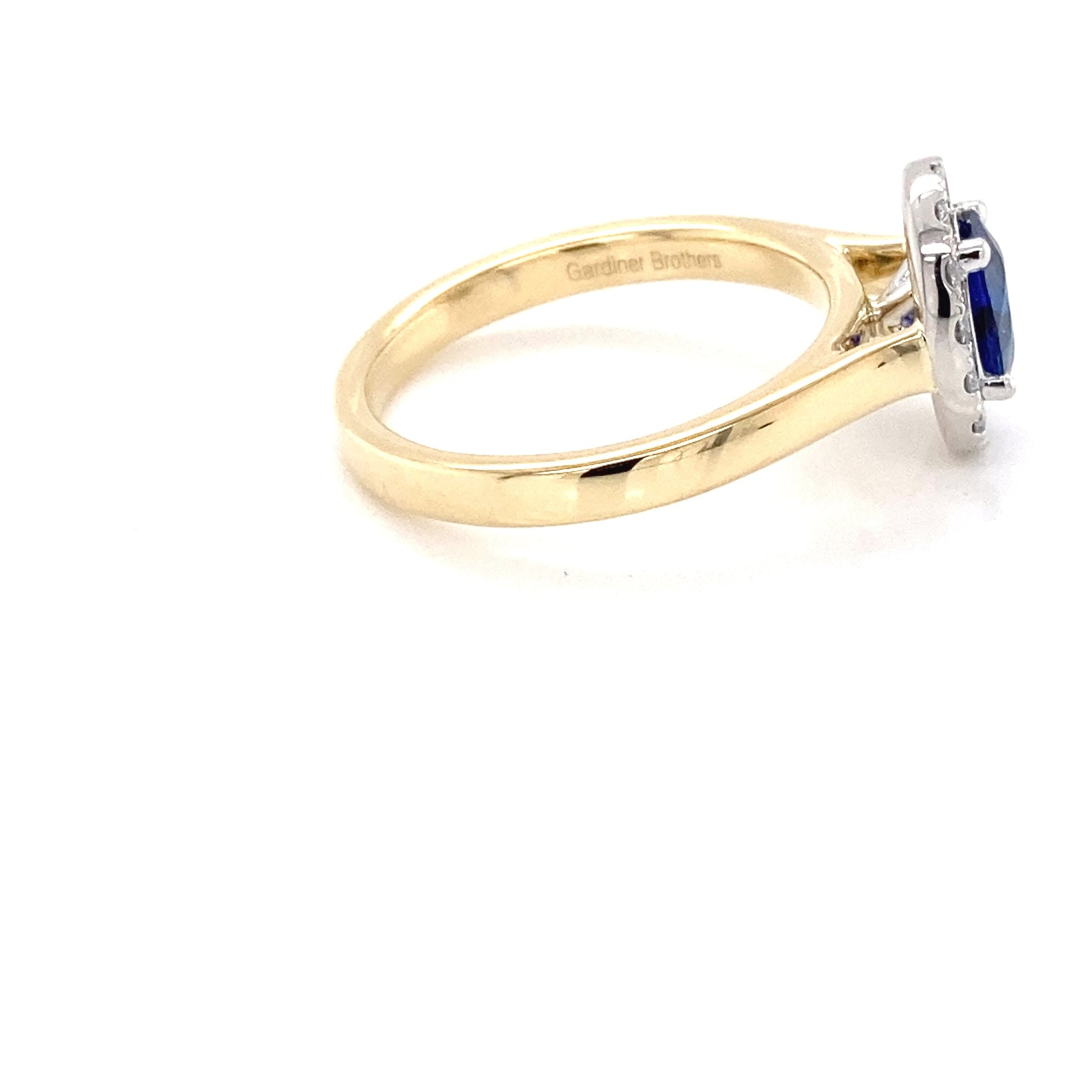 Oval Shaped Sapphire and round brilliant cut diamond halo ring Gardiner Brothers