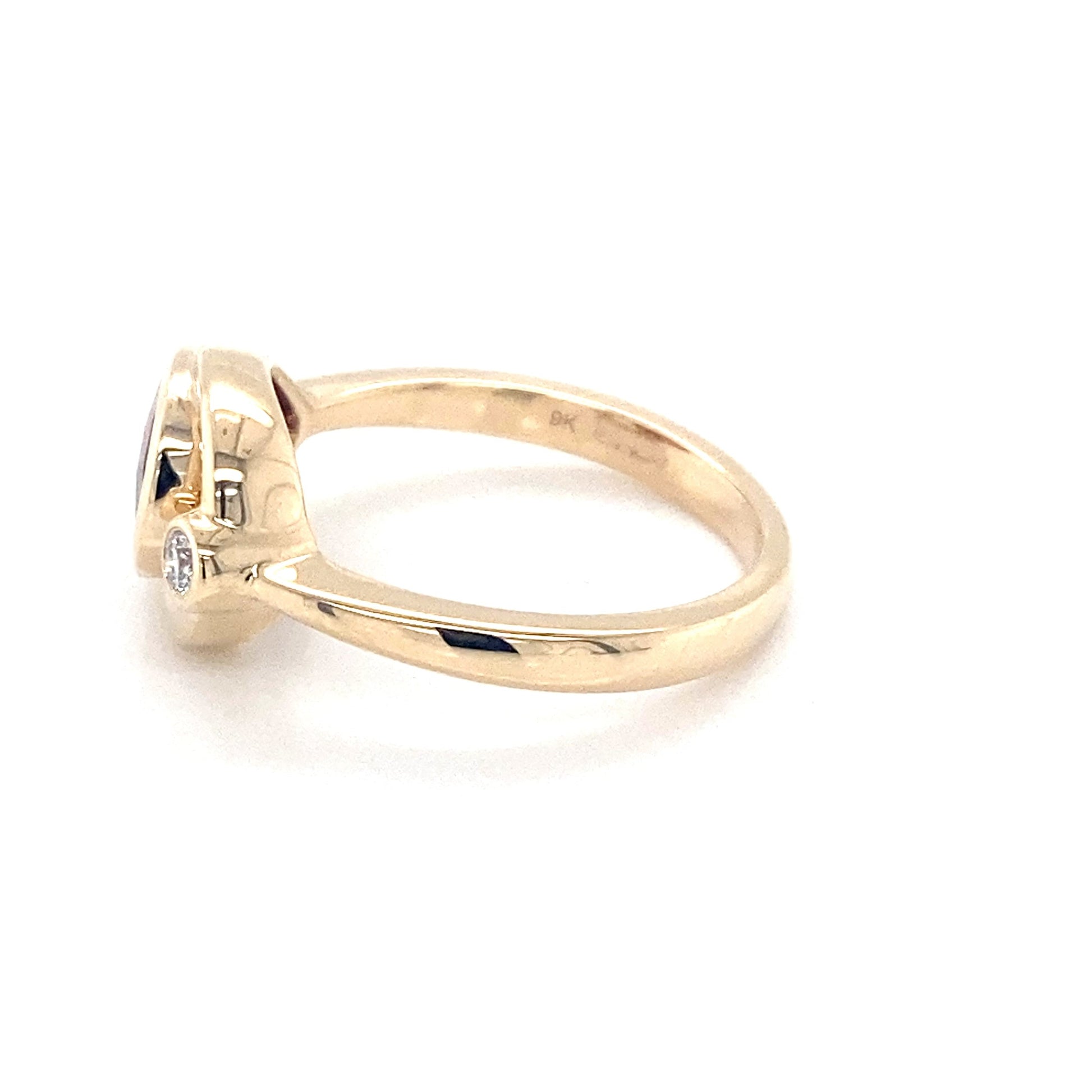 Pear shaped Garnet and round brilliant cut diamond ring Gardiner Brothers