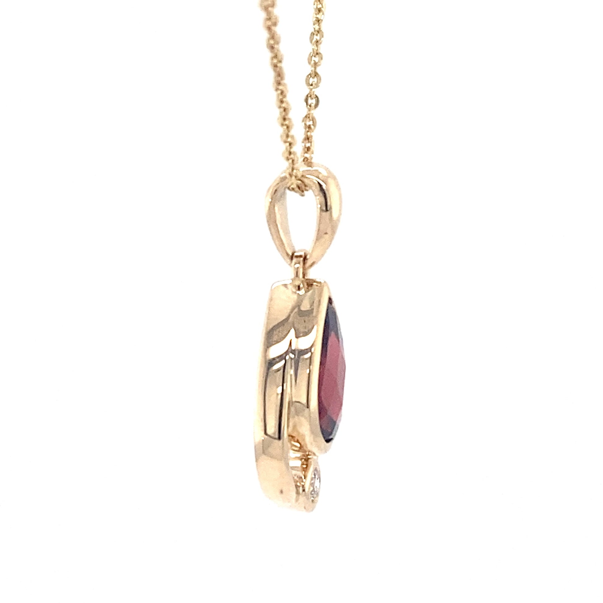 Pear shaped garnet and round brilliant cut diamond pendant Gardiner Brothers