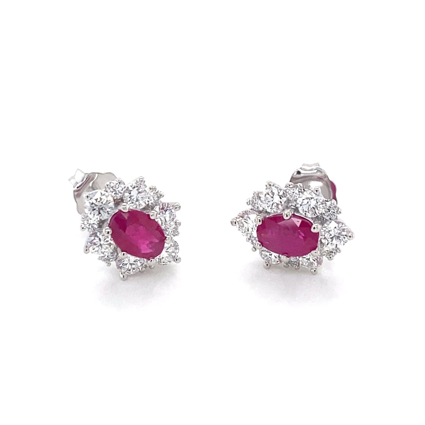 Oval Shaped Ruby and round brilliant cut diamond cluster style earrings Gardiner Brothers