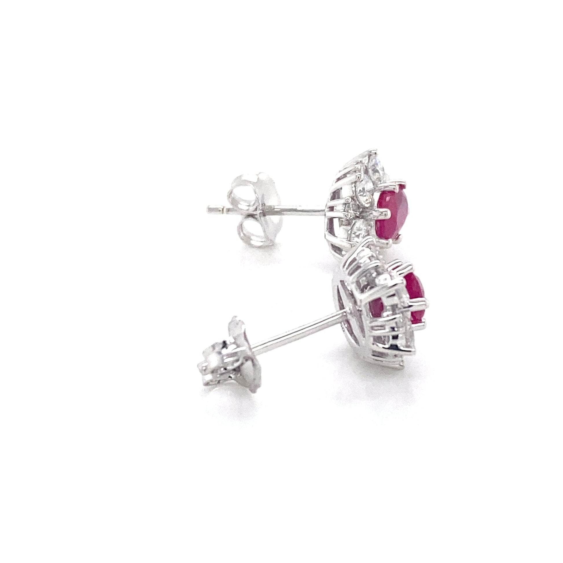 Oval Shaped Ruby and round brilliant cut diamond cluster style earrings Gardiner Brothers