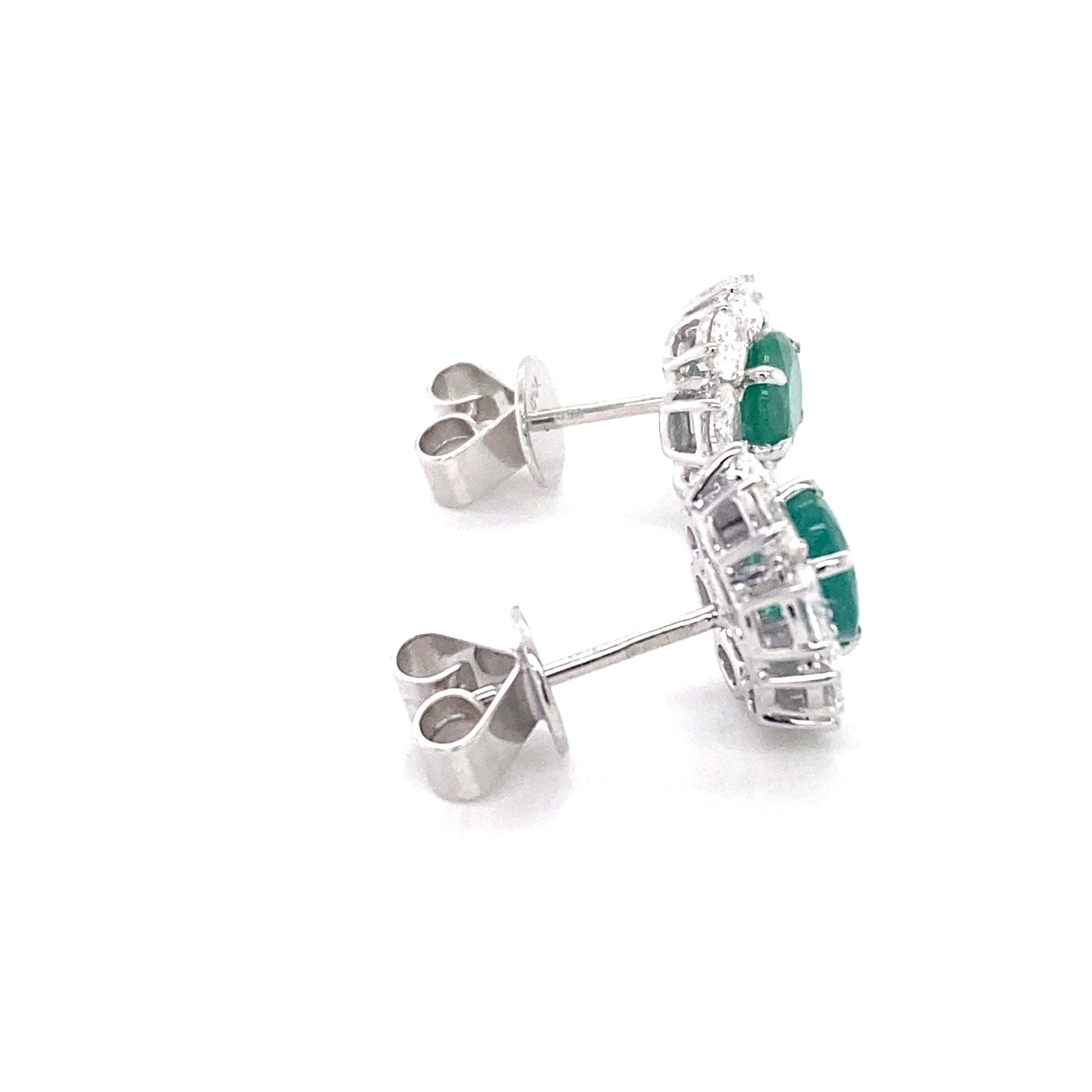 Oval shaped emerald and oval diamonds cluster style earrings Gardiner Brothers